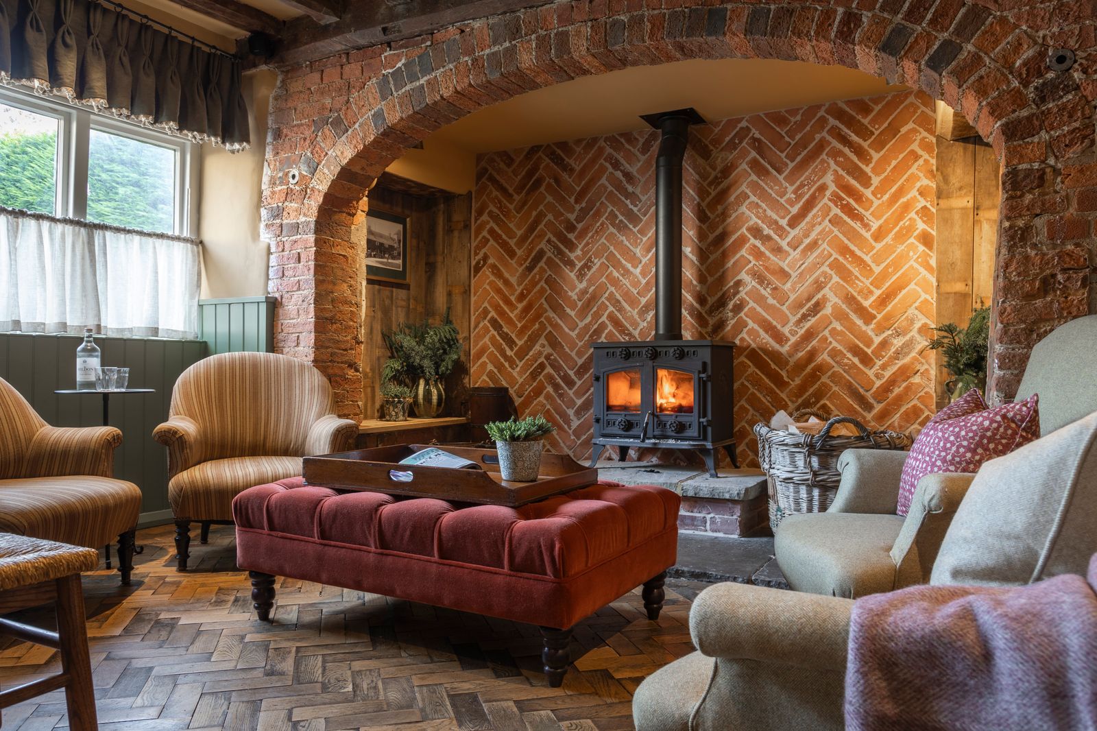 Image may contain Plant Furniture Home Decor Chair Indoors Interior Design Bench Art Painting Couch and Fireplace