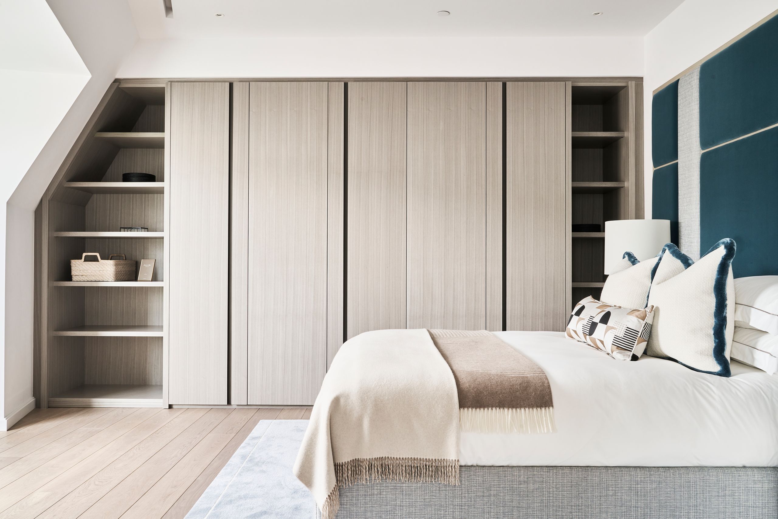 Image may contain: Indoors, Interior Design, Furniture, Closet, Wardrobe, Home Decor, Cushion, Bed, Wood Panels, and Cupboard