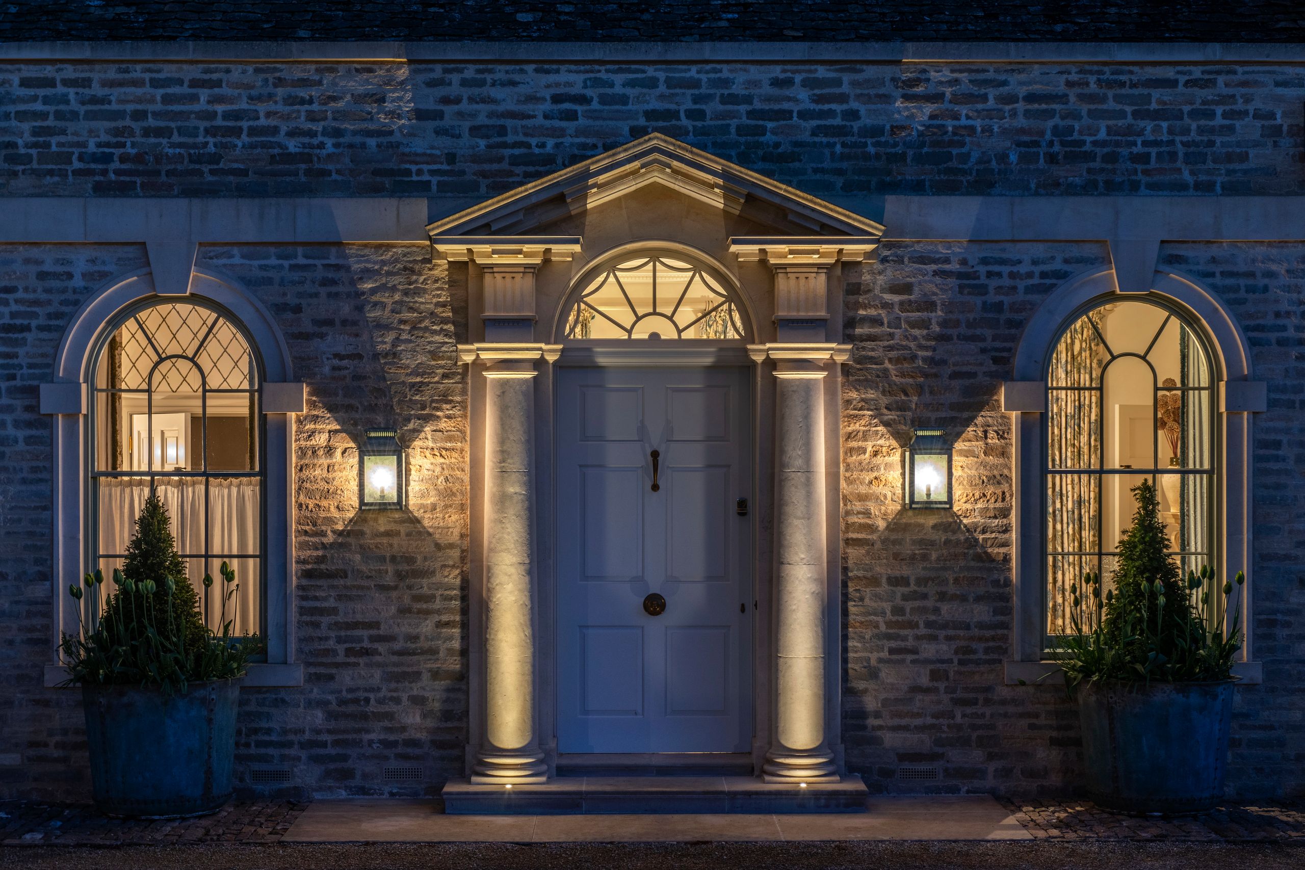 Image may contain: Architecture, Building, Housing, House, Portico, Plant, and Person