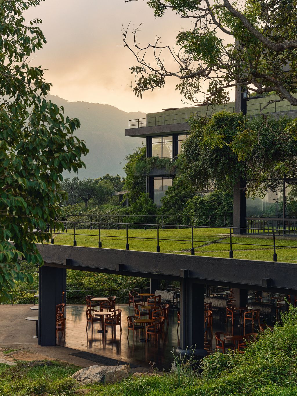 Image may contain Nature Outdoors Scenery Architecture Building Shelter Grass Plant Vegetation Desk and Furniture