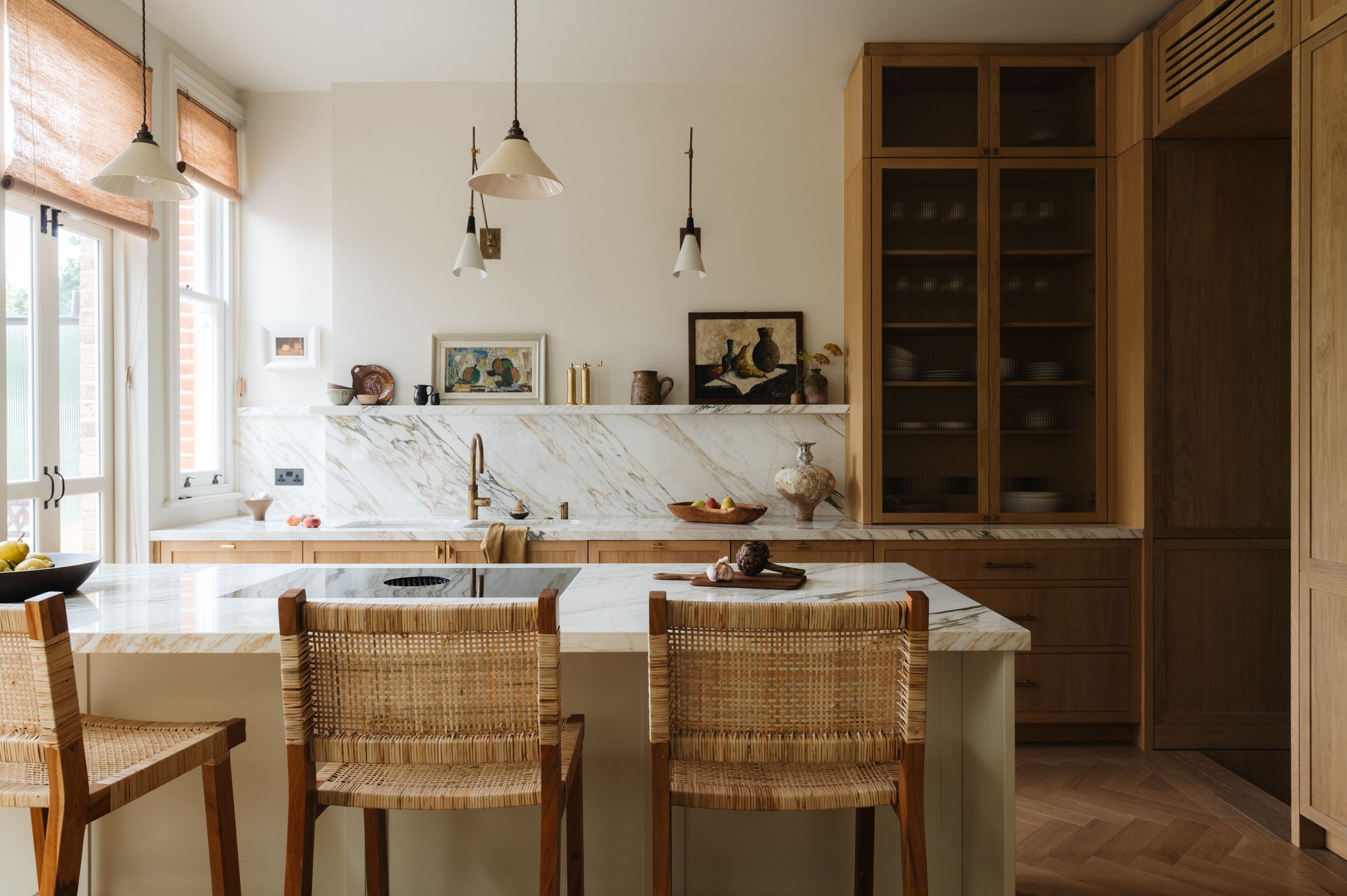 Image may contain: Indoors, Interior Design, Kitchen, Sink, Sink Faucet, Chair, Furniture, Kitchen Island, Cup, Lamp, and Art