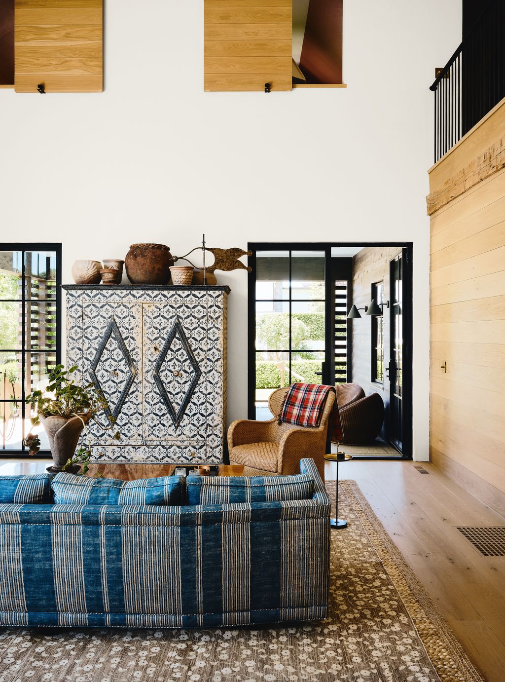 Image may contain Home Decor Indoors Interior Design Door Plant Architecture Building Furniture and Living Room