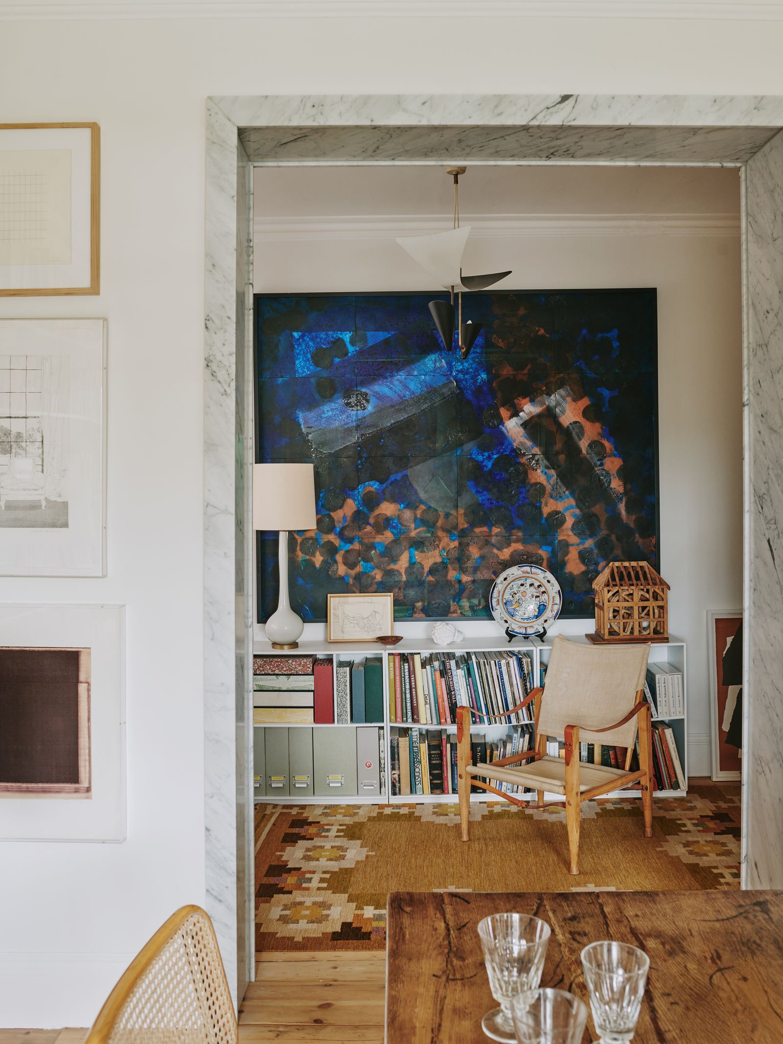 Image may contain Indoors Interior Design Lamp Chair Furniture Cup Home Decor Rug Table Plate Art and Painting