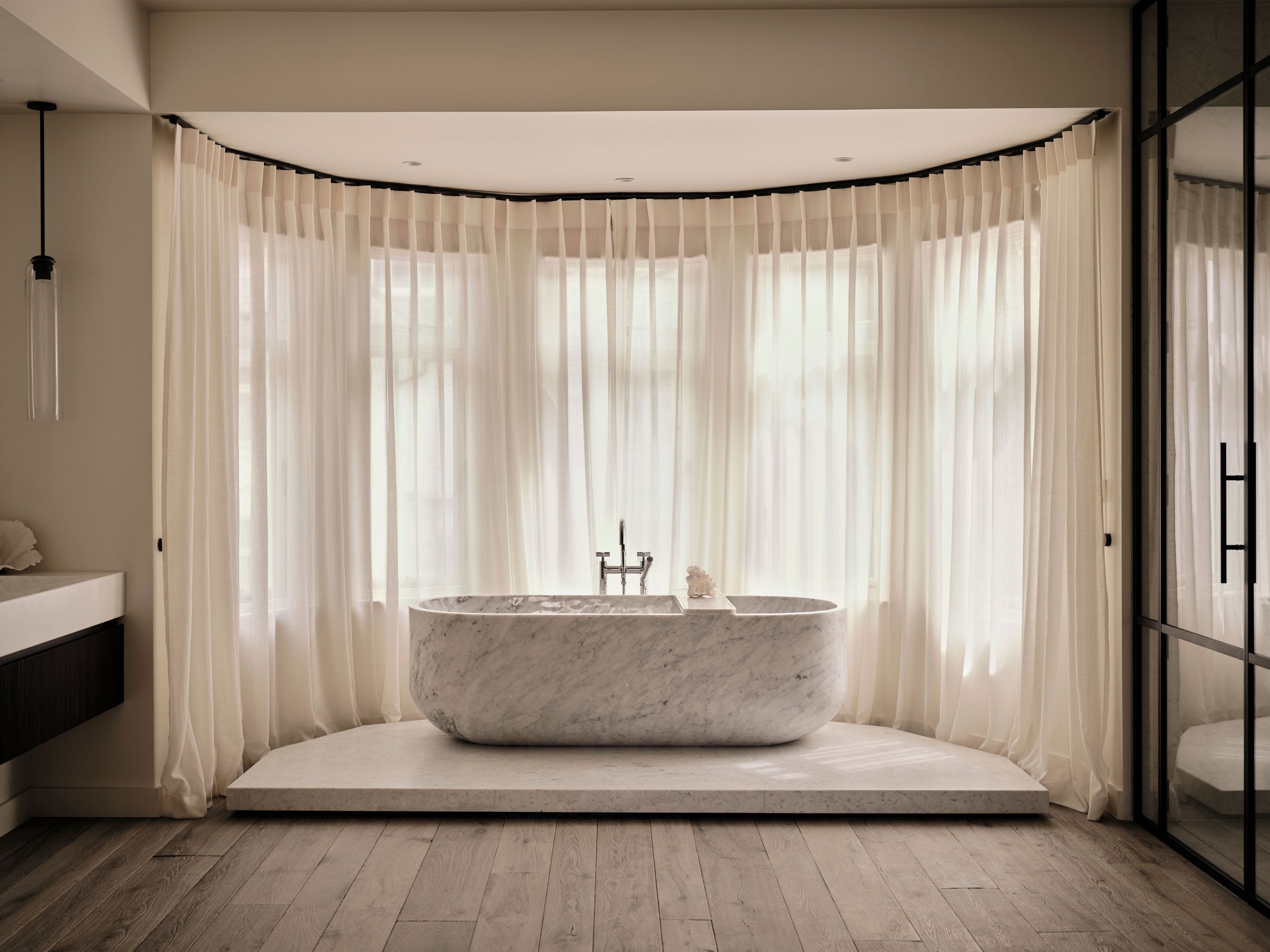 Image may contain: Indoors, Interior Design, Bathing, Tub, Bathtub, Person, Window, Sink, and Sink Faucet