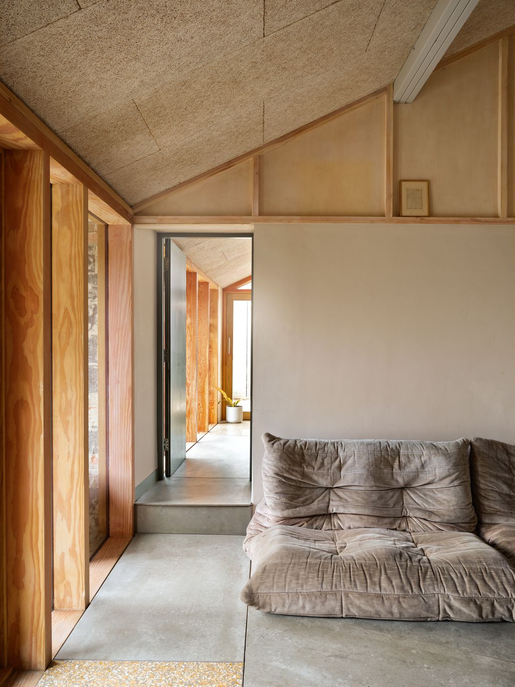 Image may contain Indoors Interior Design Floor Plant Wood Couch Furniture Flooring and Home Decor