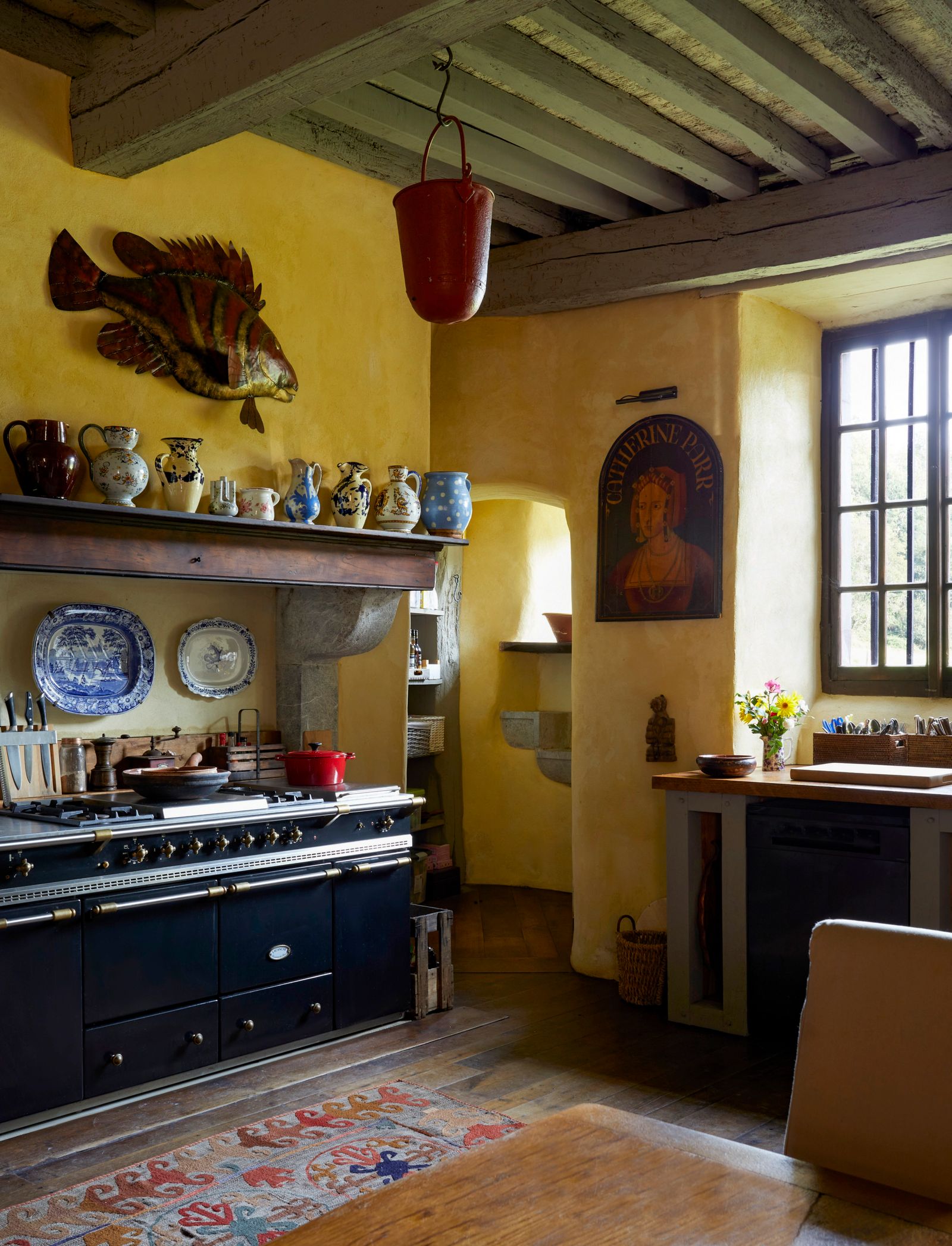 Image may contain Indoors Interior Design Home Decor Rug Plate Kitchen Cup Person Cooktop Desk and Furniture