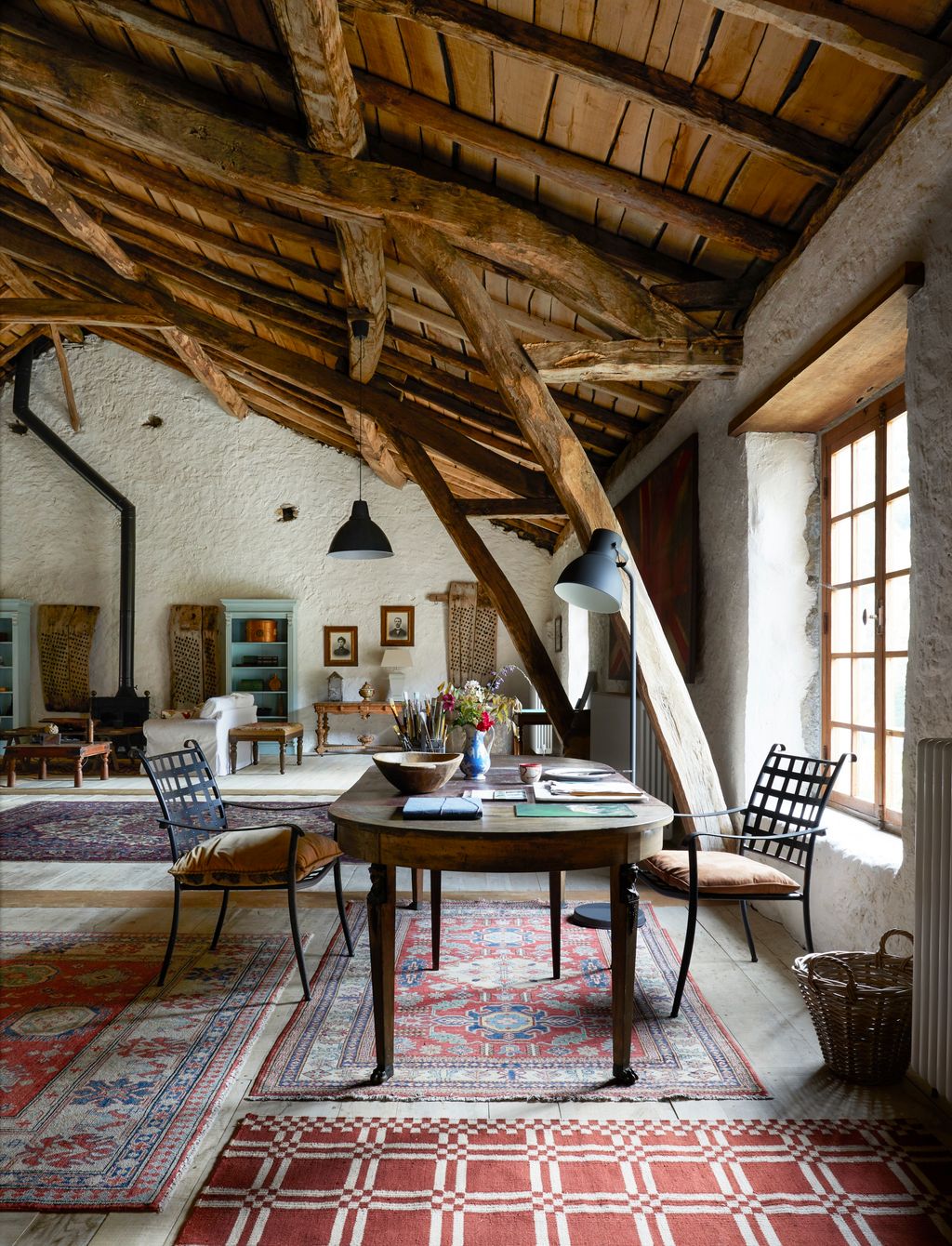 Image may contain Indoors Interior Design Home Decor Chair Furniture Table Wood Rug Floor Art Painting and Desk