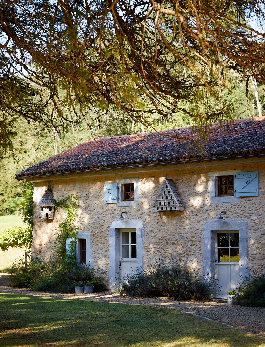 Image may contain Architecture Building Cottage House Housing Grass Plant Tree Villa Outdoors Shelter and Lamp