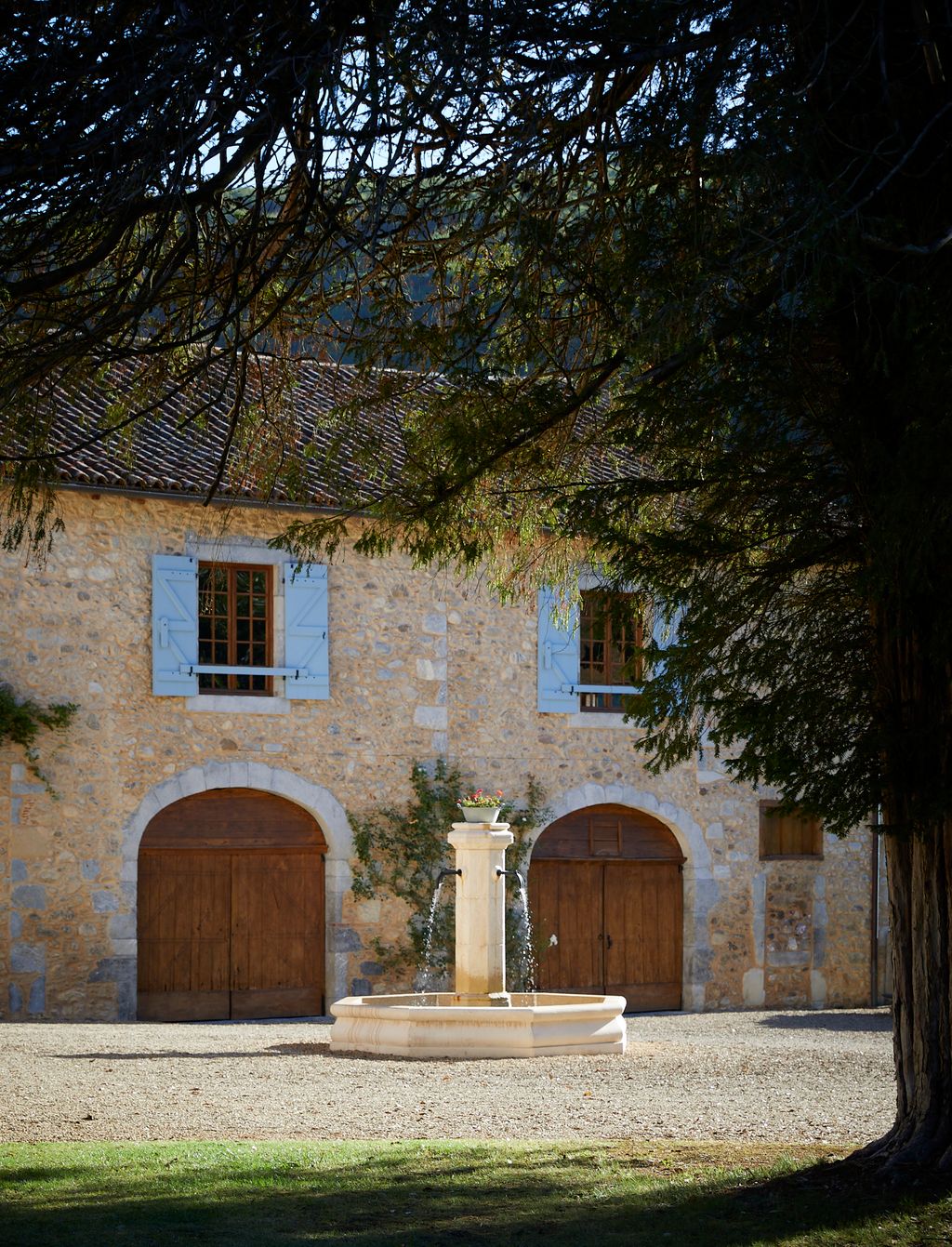 Image may contain Architecture Building House Housing Villa Plant Tree Arch Grass Gothic Arch and Road