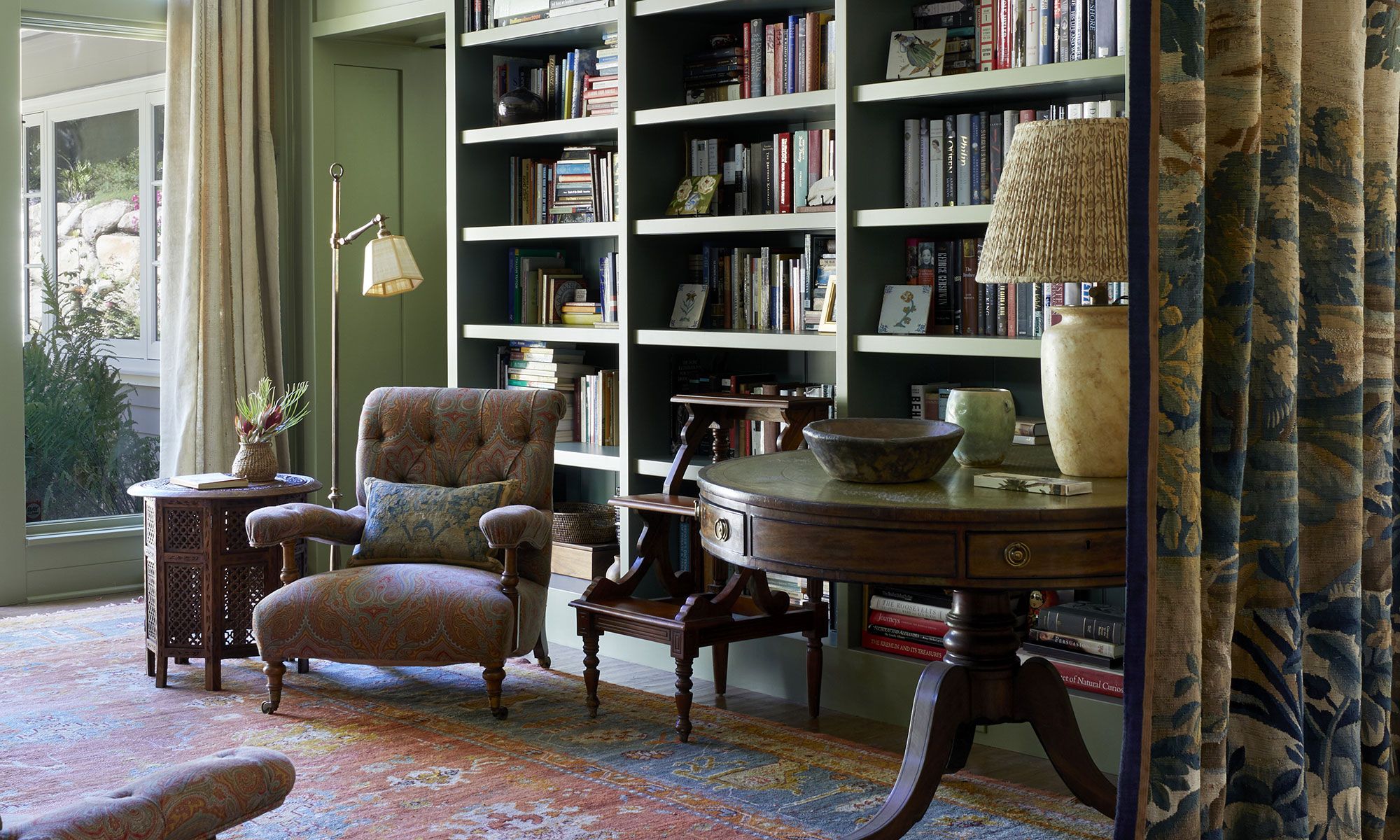 Image may contain: Lamp, Furniture, Chair, Book, Publication, Desk, Table, Bookcase, Cup, and Home Decor