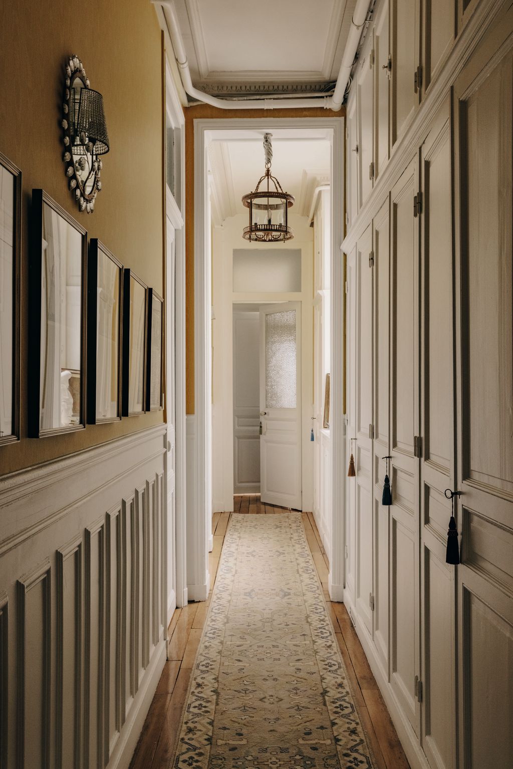 Image may contain Indoors Interior Design Home Decor Rug Lamp Hallway Architecture Building and Foyer