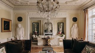 Image may contain Home Decor Chandelier Lamp Architecture Building Furniture Indoors Living Room Room and Book