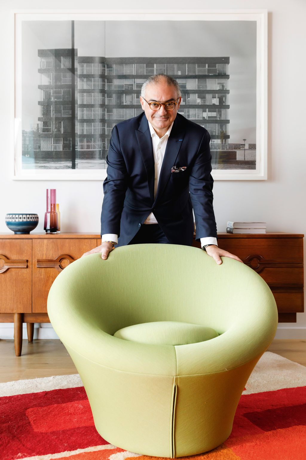 Image may contain Furniture Accessories Glasses Adult Person Home Decor Rug Chair Wristwatch and Sitting