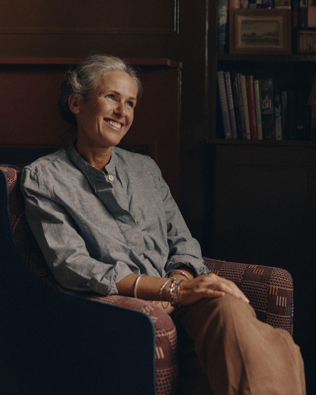 Image may contain Adult Person Sitting Senior Citizen Face Happy Head Smile Art Painting Chair and Furniture