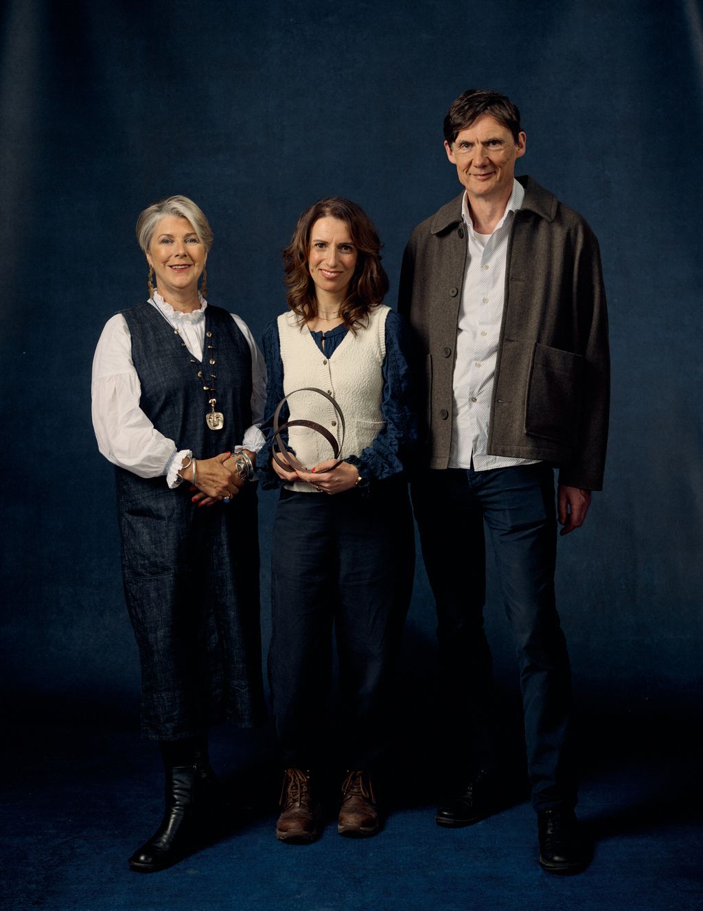 Image may contain Clothing Coat Jacket Blazer People Person Pants Footwear Shoe Adult Groupshot and Accessories