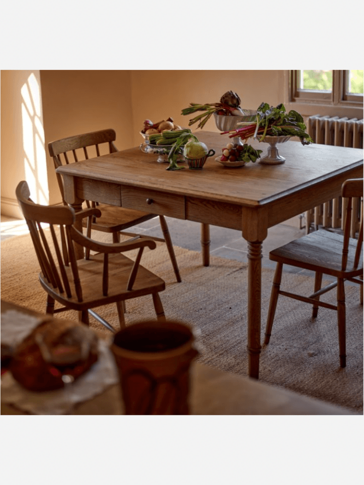 Image may contain: Dining Table, Furniture, Table, Architecture, Building, Dining Room, Indoors, Room, Wood, and Flower