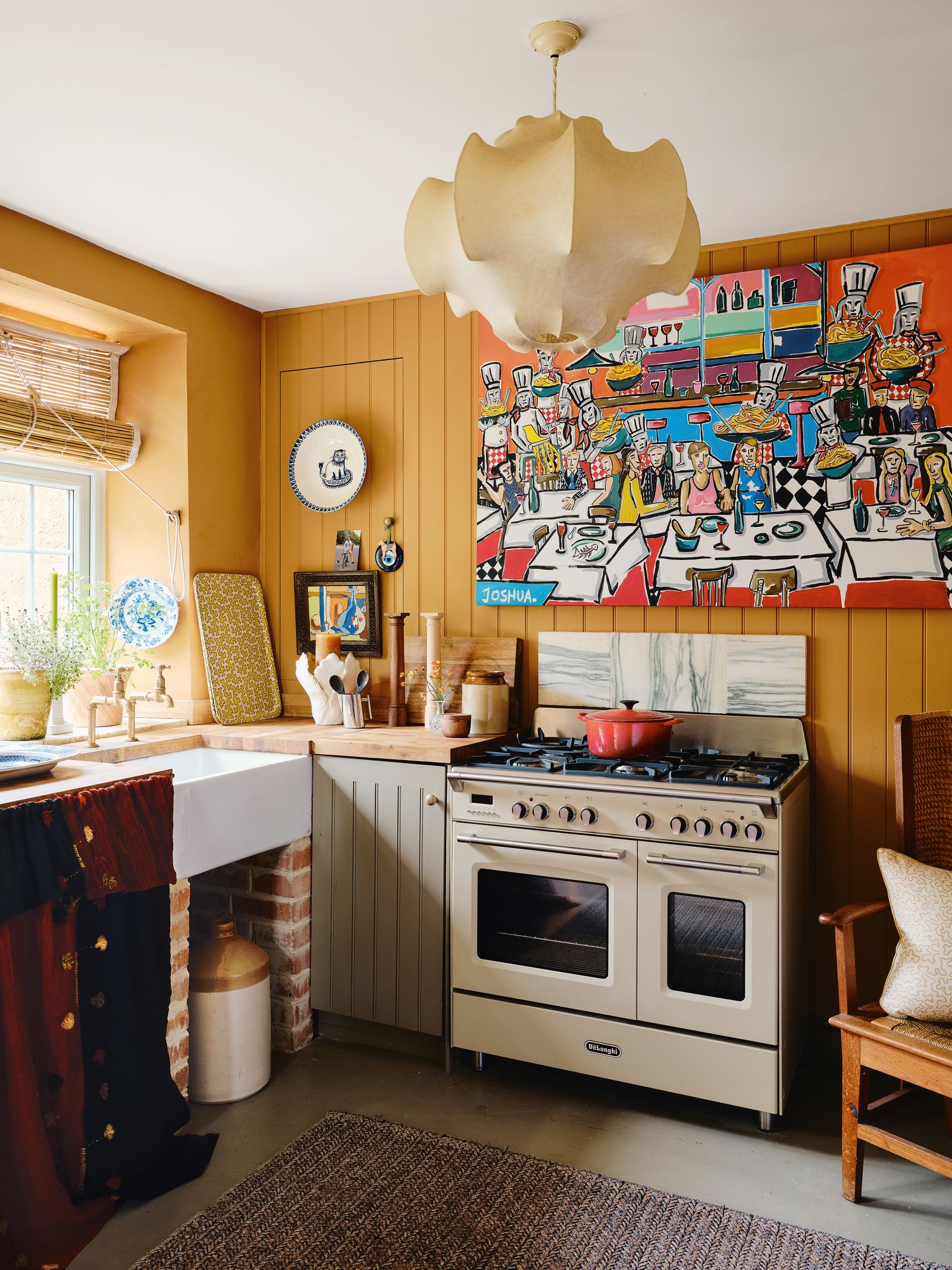 Image may contain Indoors Interior Design Home Decor Rug Kitchen Chair Furniture Sink Art Painting and Plant