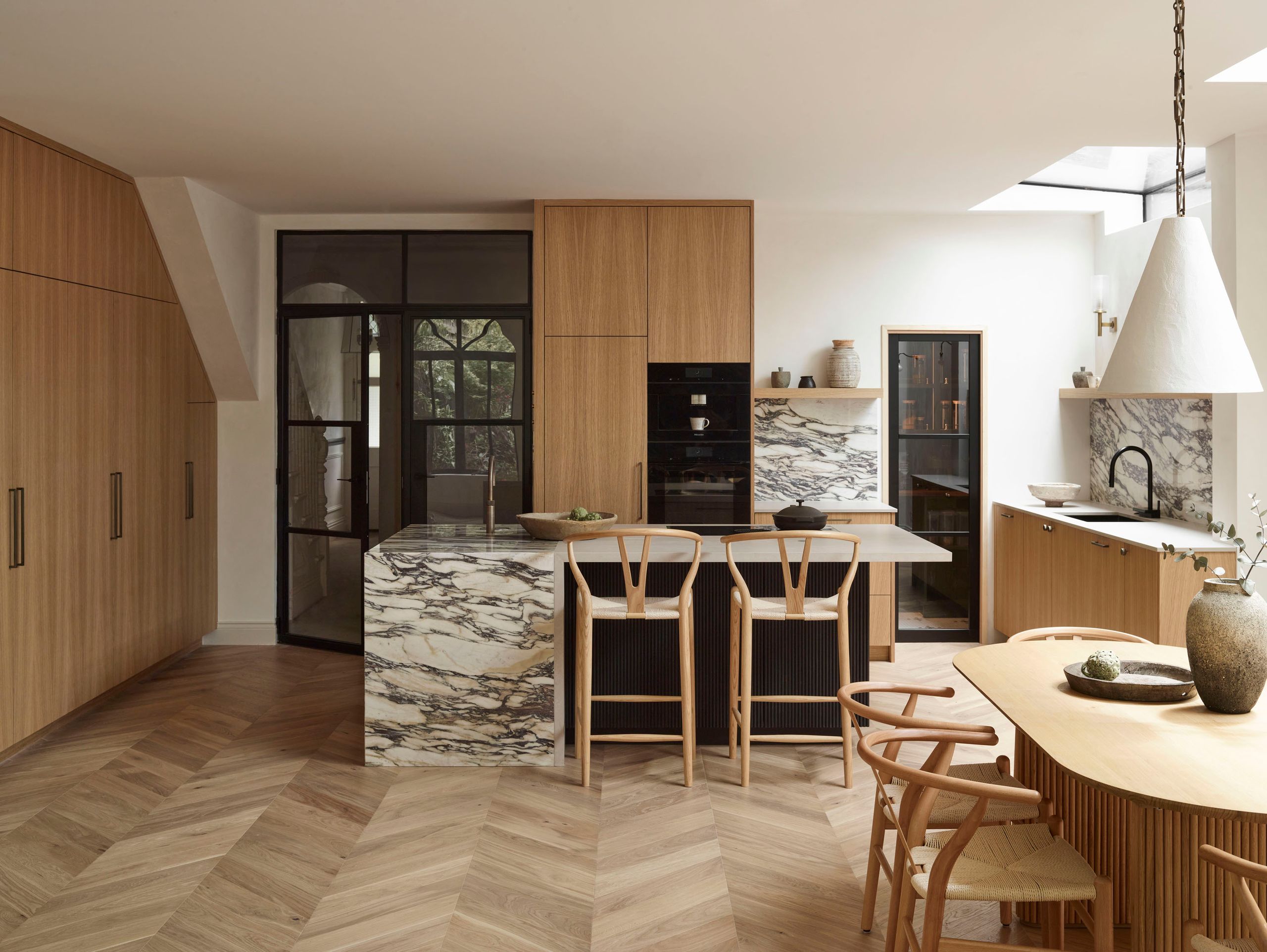 Image may contain: Indoors, Interior Design, Chair, Furniture, Dining Table, Table, Lamp, Architecture, and Building