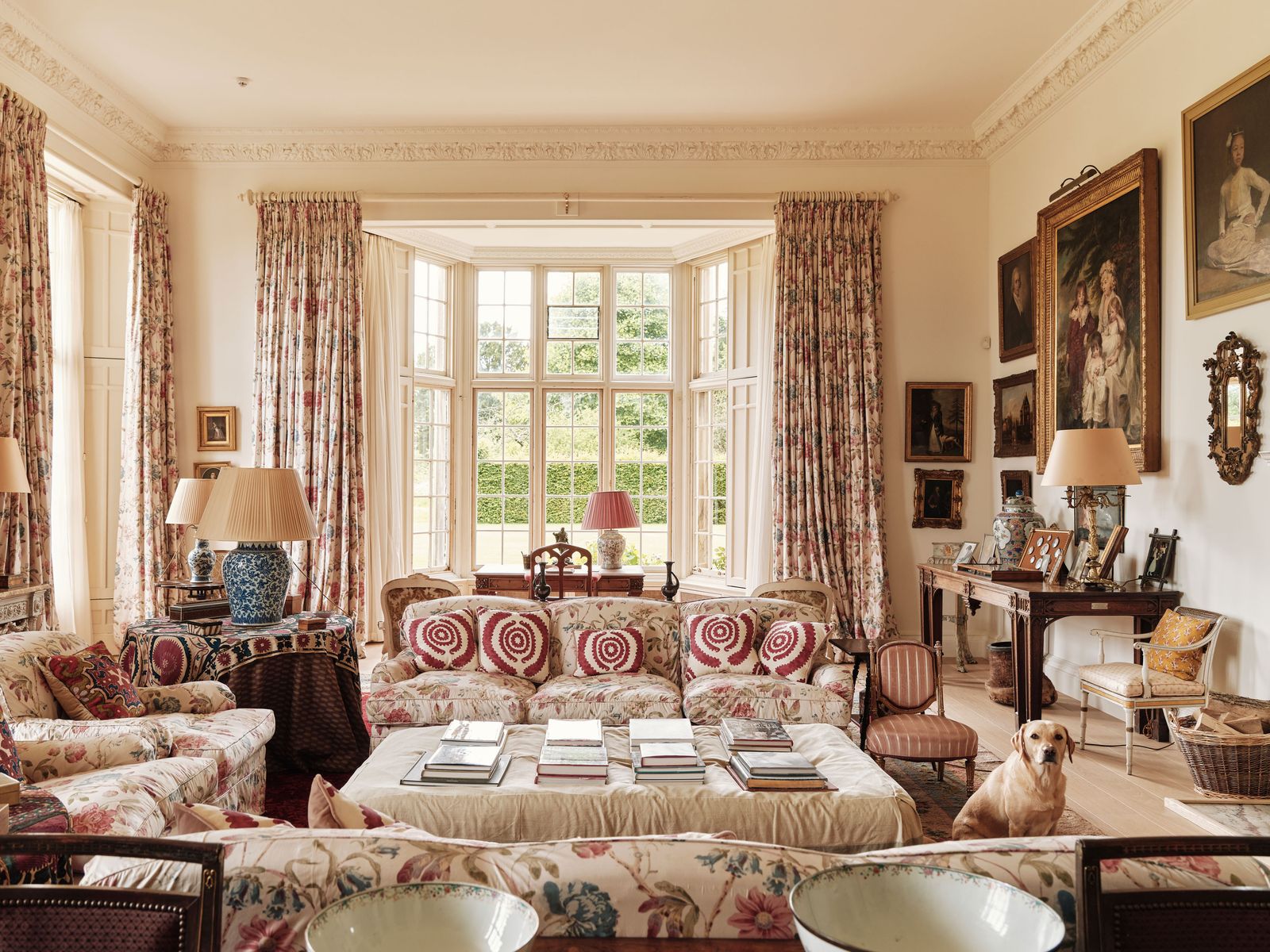 Image may contain Home Decor Chair Furniture Lamp Art Painting Desk Table Person Book Publication and Animal