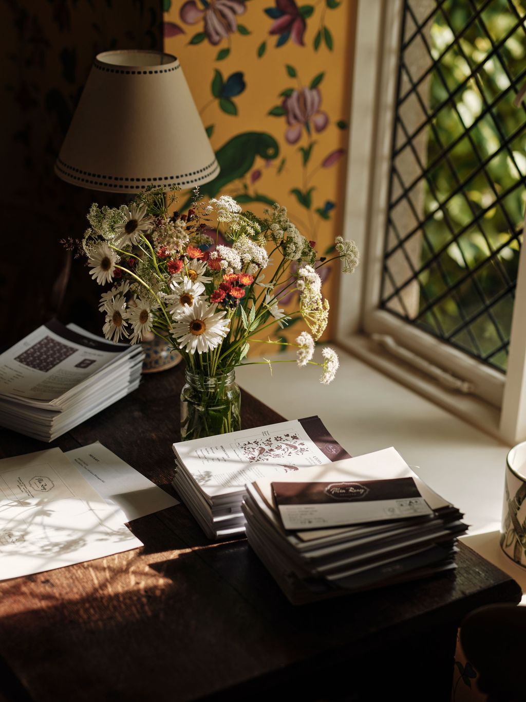 Image may contain Lamp Text Cup Desk Furniture Table Document Receipt Adult and Person