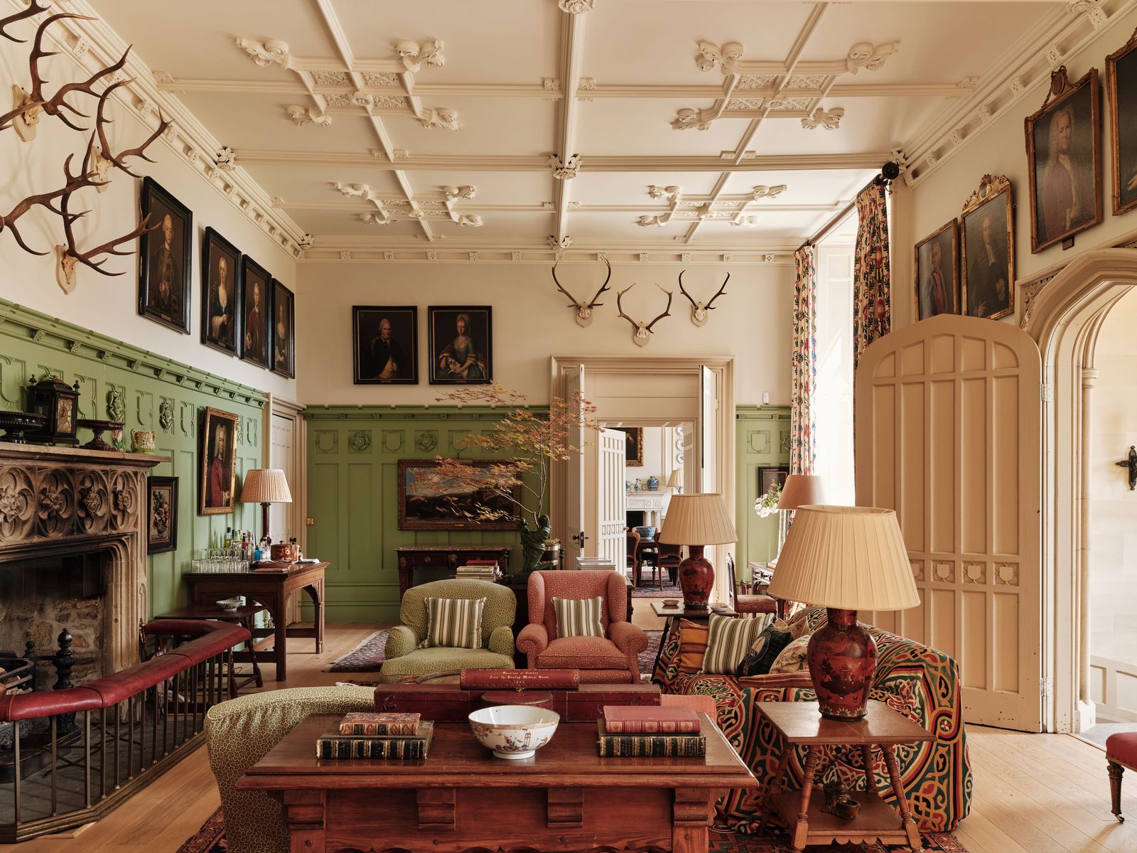 Image may contain Home Decor Lamp Architecture Building Furniture Indoors Living Room Room Art Painting and Couch