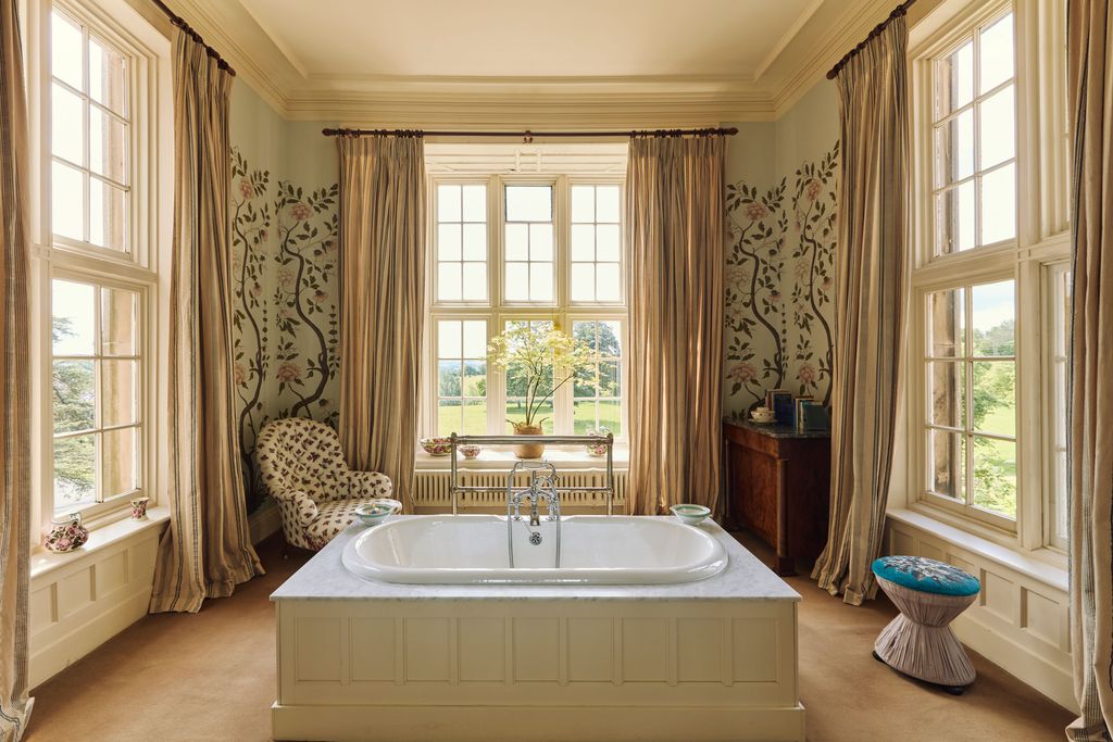 Image may contain Bathing Tub Bathtub Person Window Chair Furniture and Plant