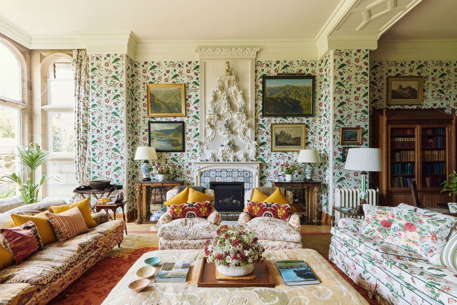 Image may contain Home Decor Lamp Art Painting Book Publication Cushion Couch Furniture Plant and Architecture