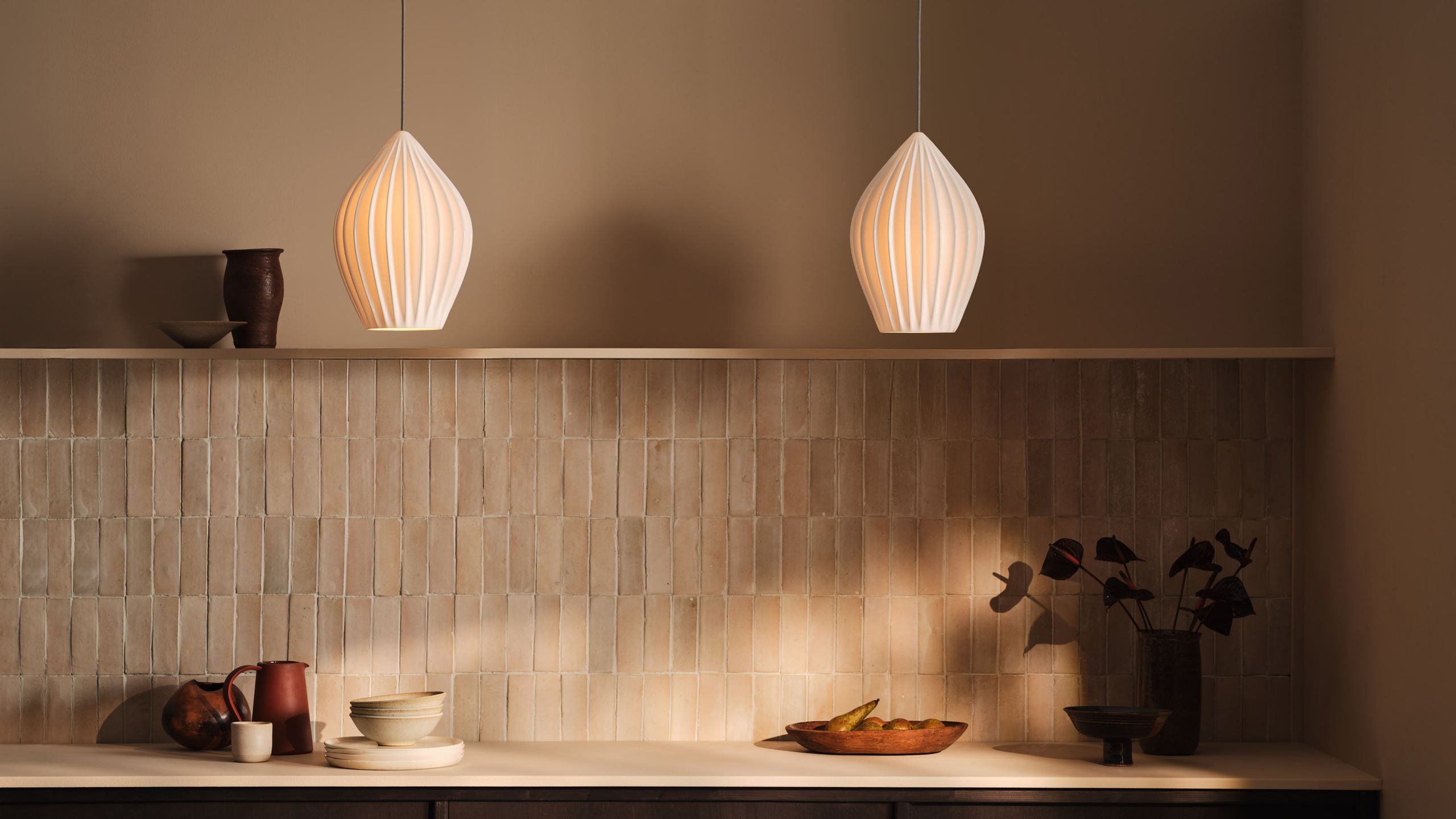 Image may contain: Indoors, Interior Design, Lighting, Lamp, Cup, Architecture, Building, Wall, and Plant