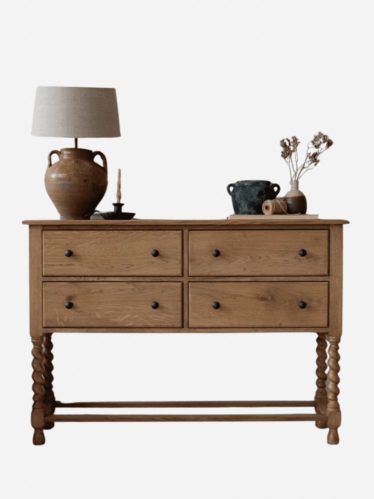 Image may contain: Furniture, Sideboard, Drawer, Cabinet, Lamp, Table Lamp, Table, and Candle