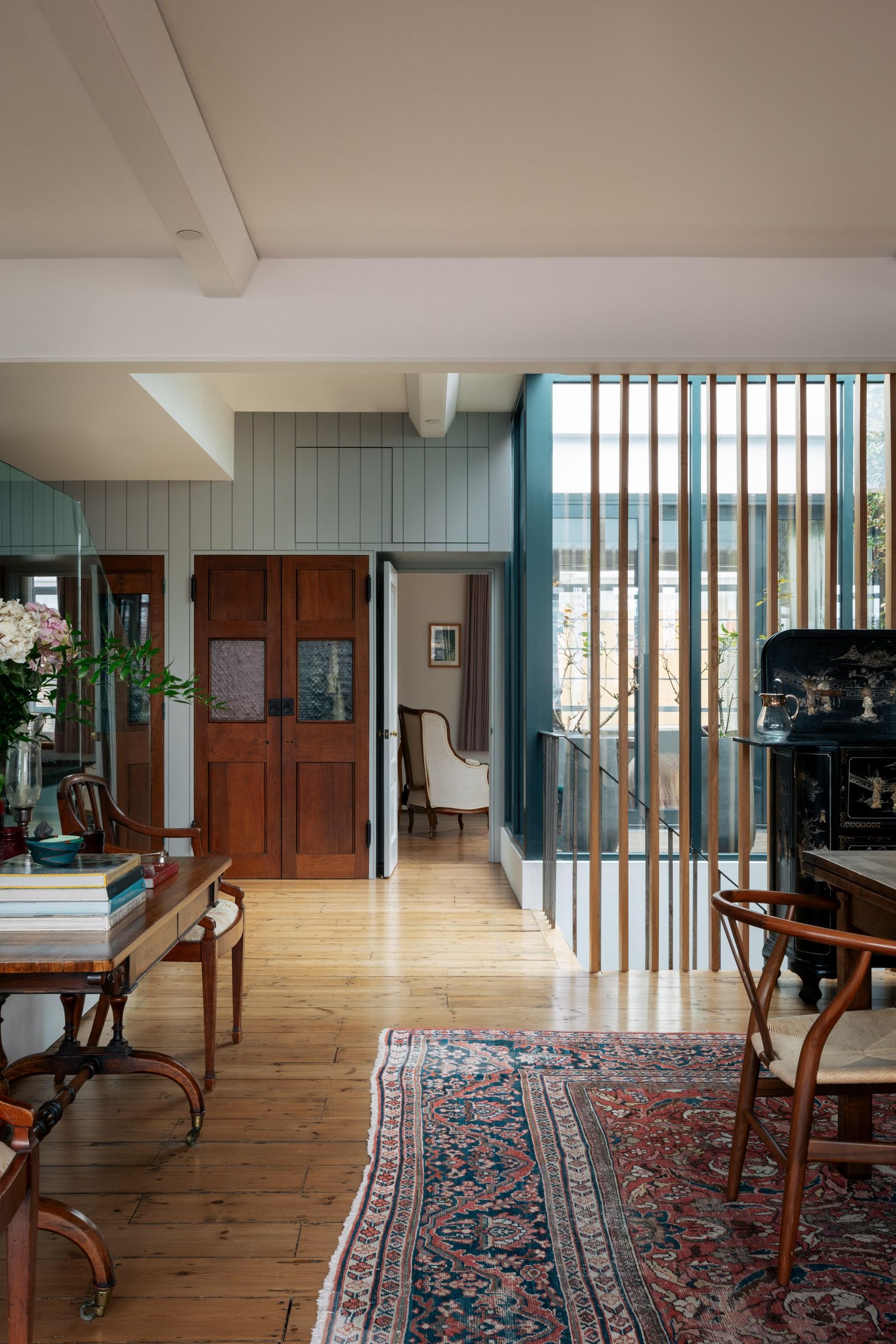 Image may contain Indoors Interior Design Home Decor Rug Chair Furniture Floor Door Art Painting and Architecture