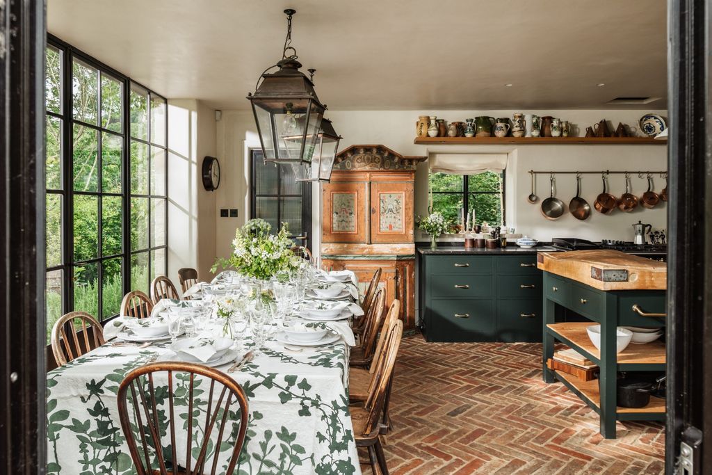 Image may contain Architecture Building Dining Room Dining Table Furniture Indoors Room Table Chair and Lamp