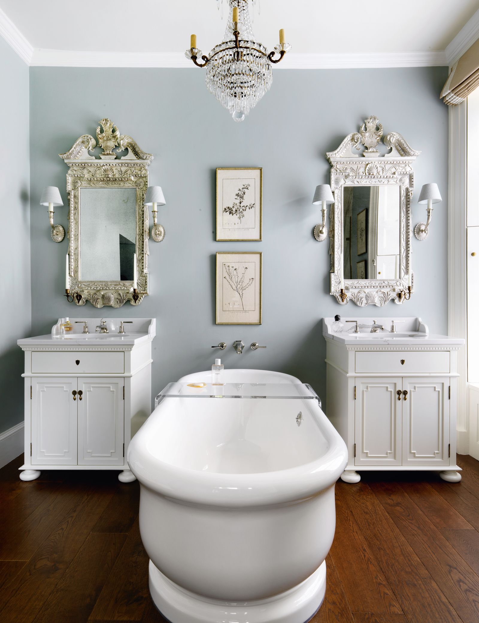 Image may contain Lamp Indoors Interior Design Bathing Tub Chandelier Art Painting Bathtub Person and Sink