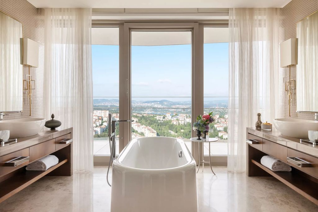 Image may contain Bathing Bathtub Person Tub Sink Indoors Interior Design Sink Faucet Desk Furniture and Table