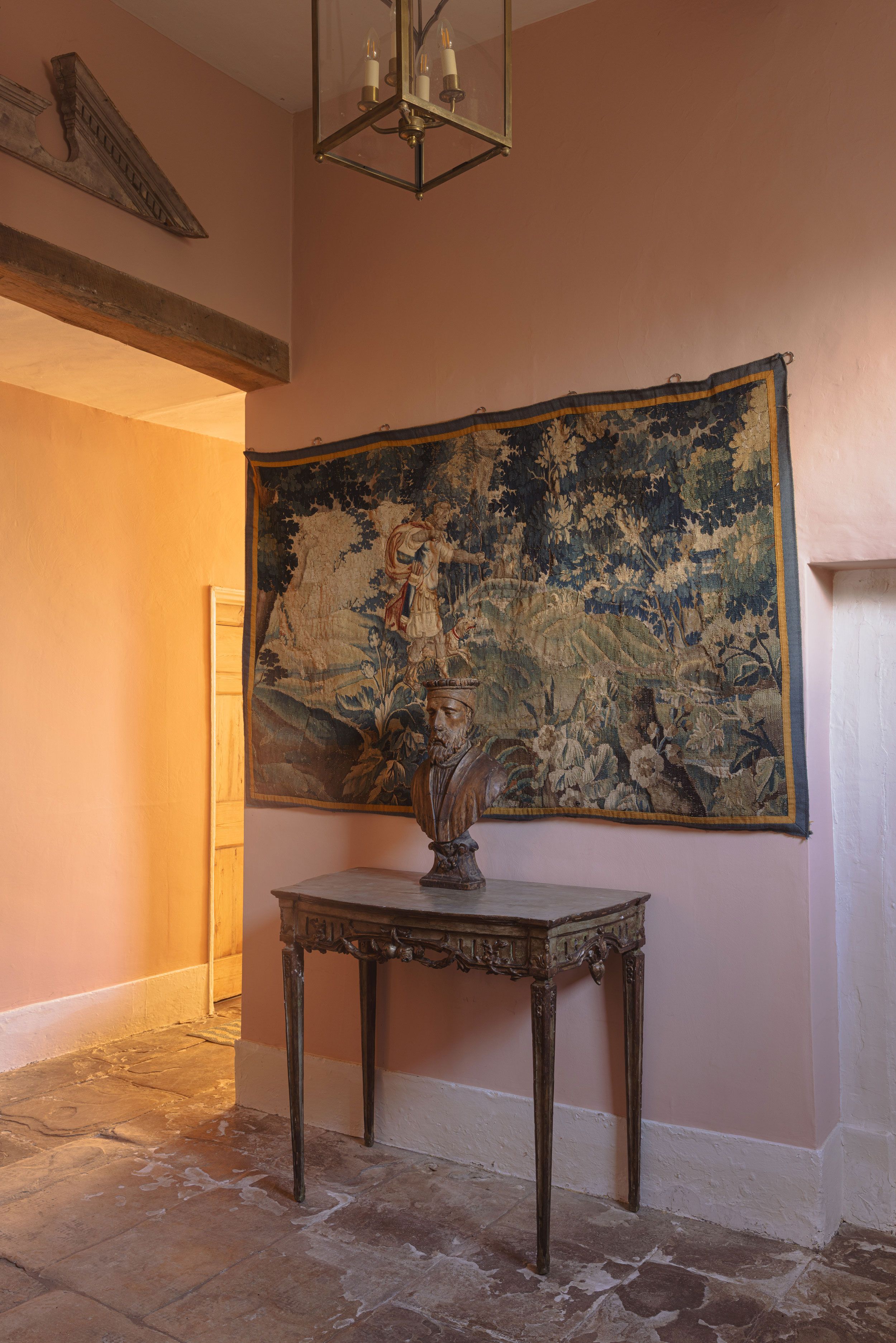 Image may contain: Desk, Furniture, Table, Indoors, Interior Design, Floor, Lamp, Art, Person, Flooring, and Accessories