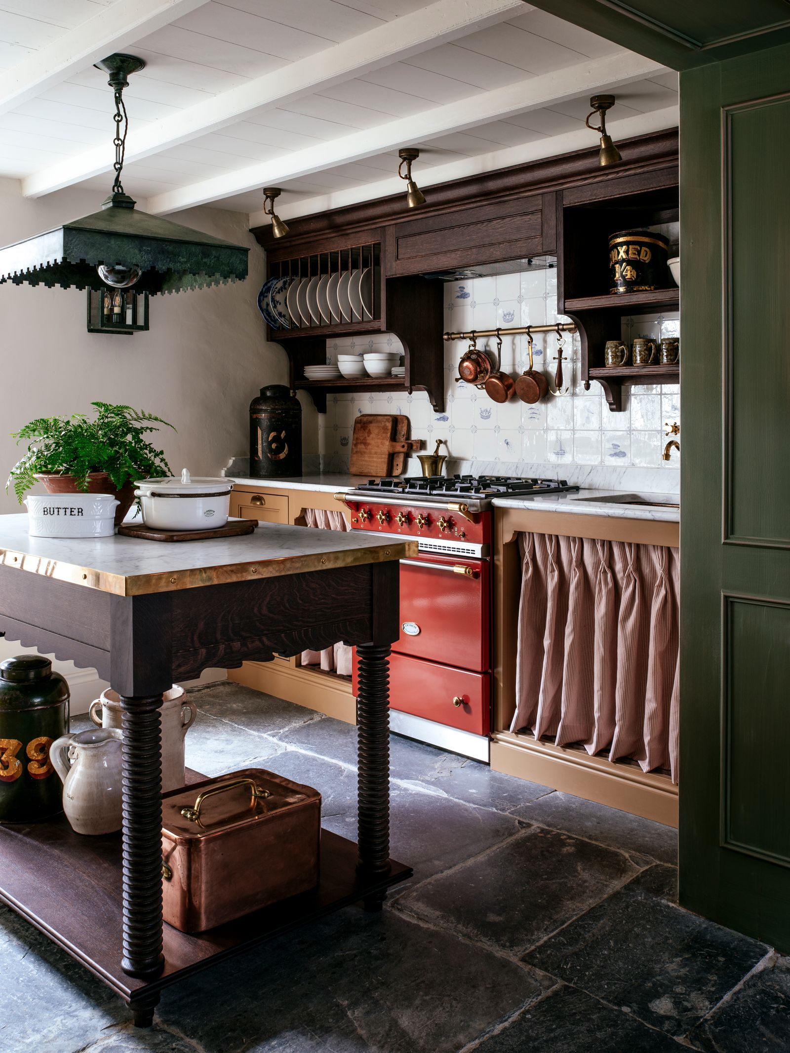 Image may contain Indoors Interior Design Kitchen Floor Plant Kitchen Island Cup Lamp Flooring Box and Desk