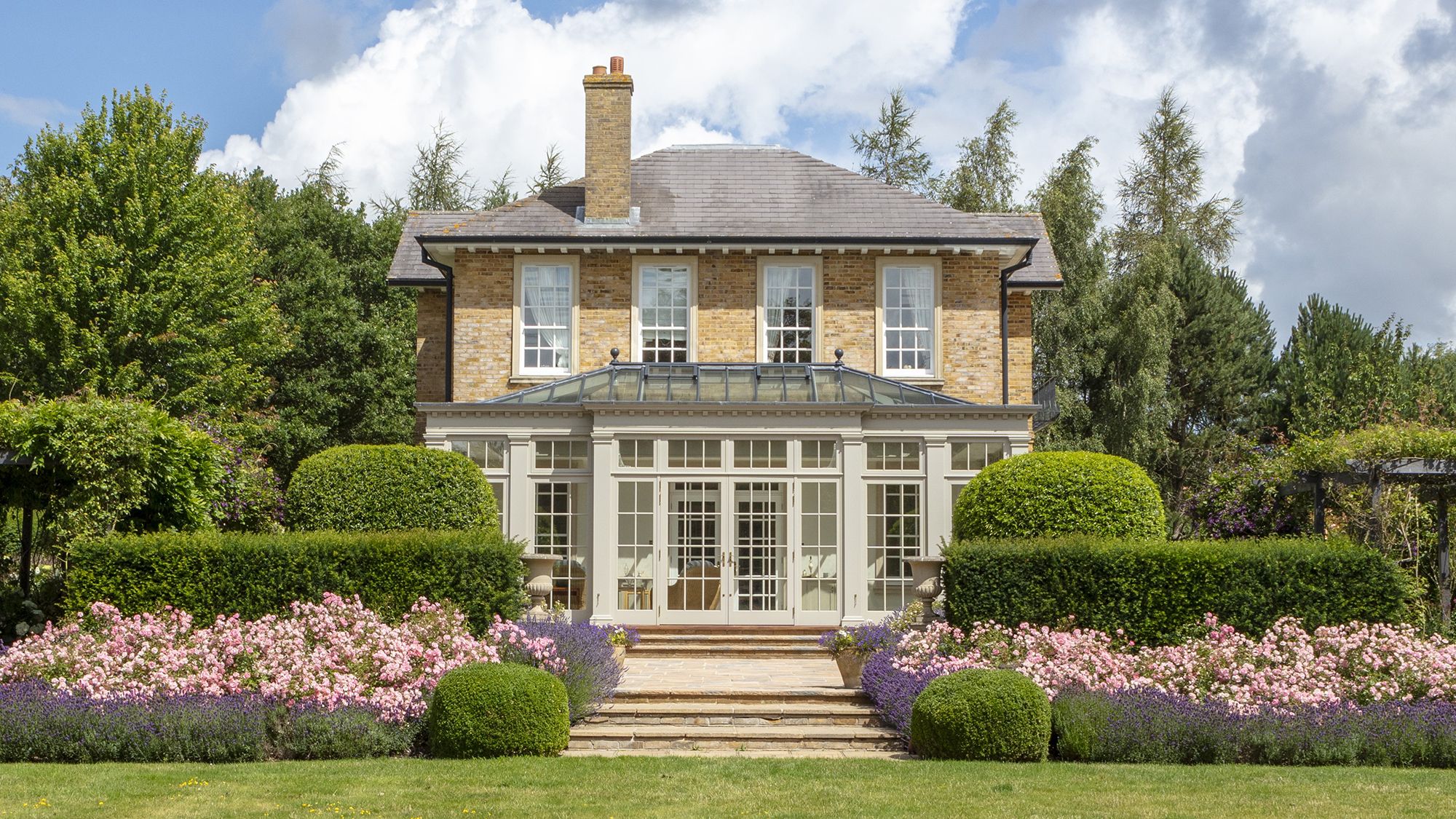 Image may contain: Architecture, Building, Housing, Grass, Plant, House, Fence, Hedge, Manor, and Outdoors