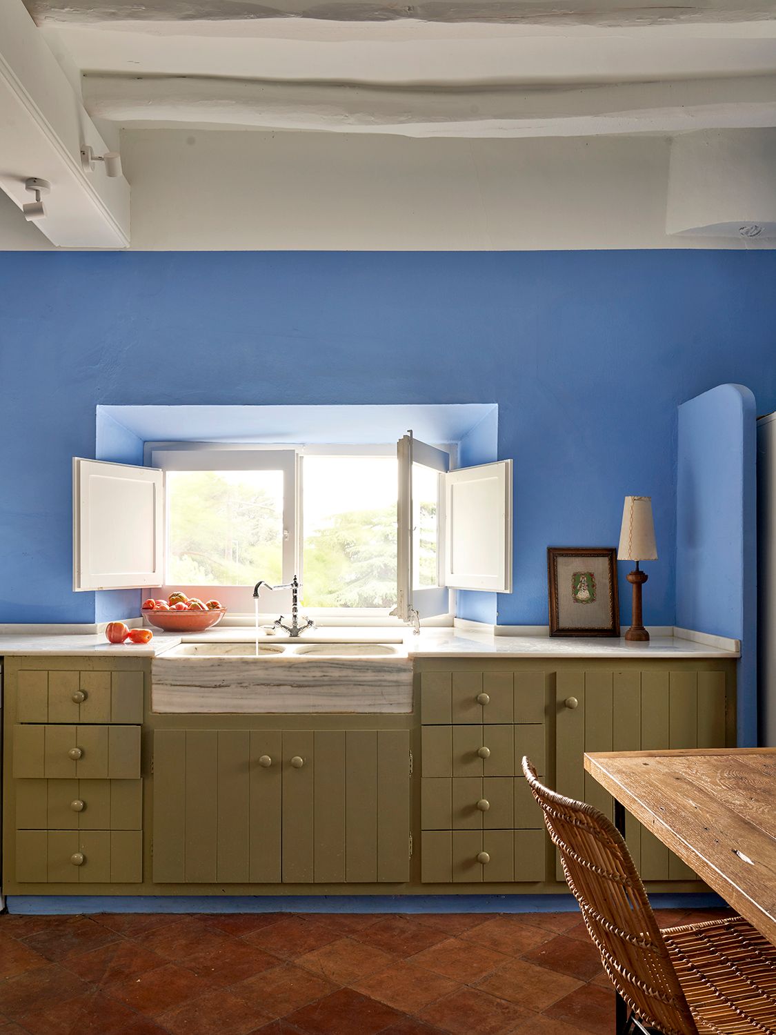 Image may contain Indoors Interior Design Lamp Chair Furniture Sink Sink Faucet Desk Table Art and Painting