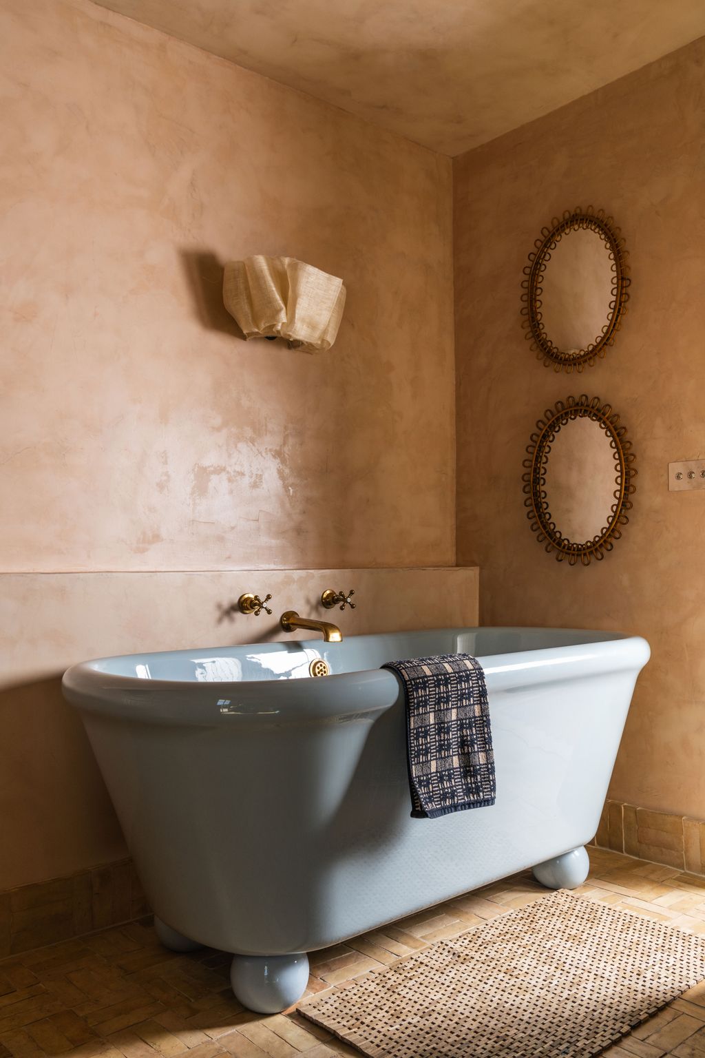 Image may contain Bathing Bathtub Person Tub Sink Sink Faucet Home Decor Rug Indoors and Interior Design