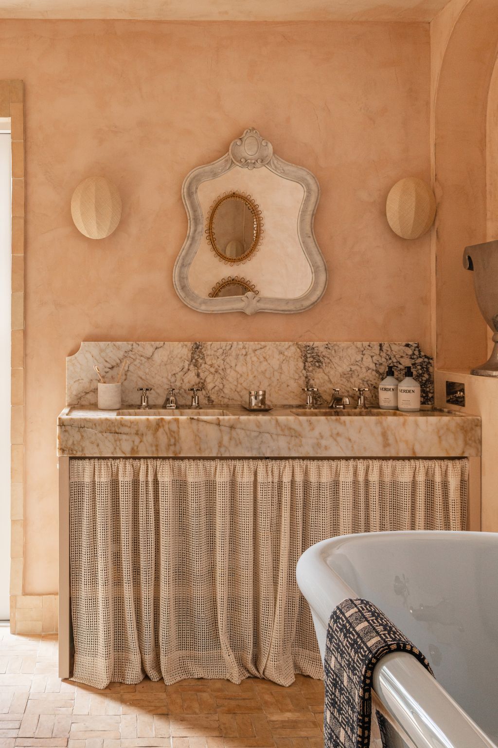 Image may contain Indoors Interior Design Bathing Cup Bathtub Person Tub Sink and Sink Faucet