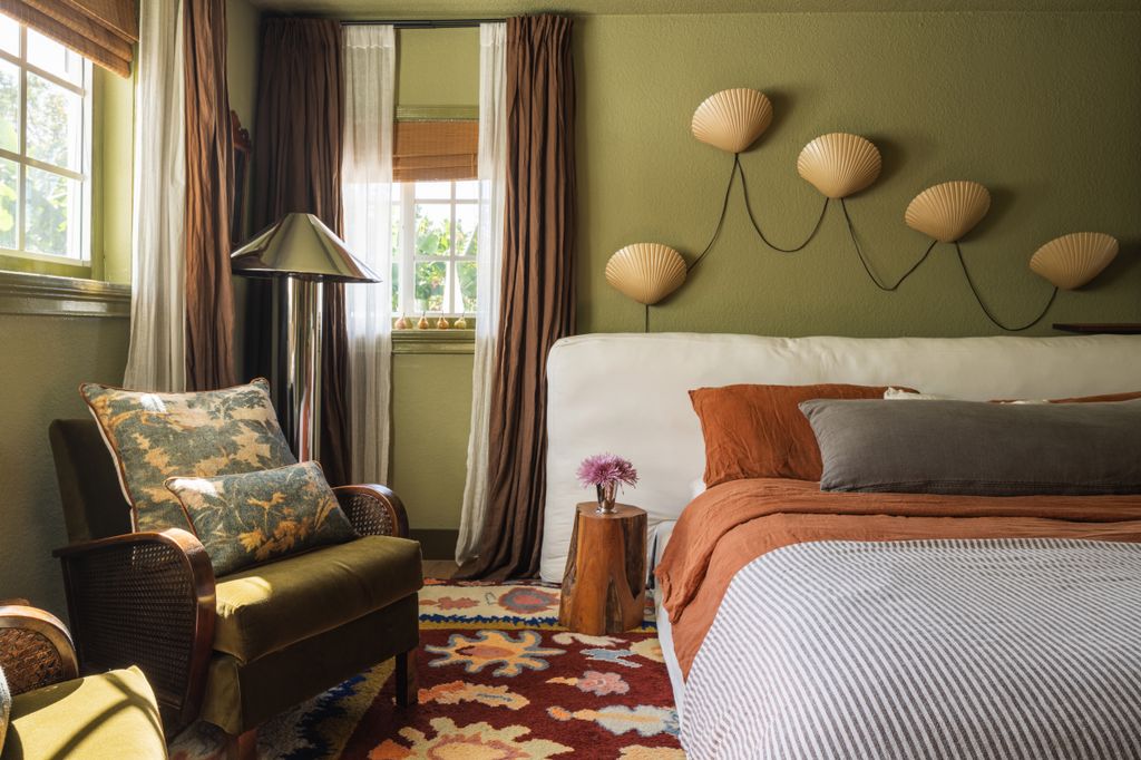 Image may contain Home Decor Cushion Lamp Chair Furniture Bed Rug Desk Table Indoors Bedroom Room and Pillow