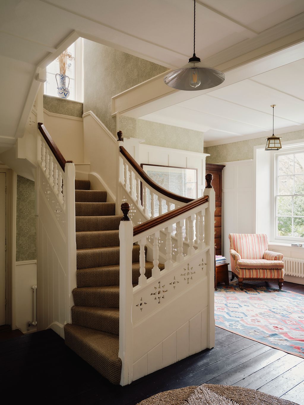 Image may contain Architecture Building Foyer Indoors Lamp House Housing Staircase Home Decor Rug and Chair