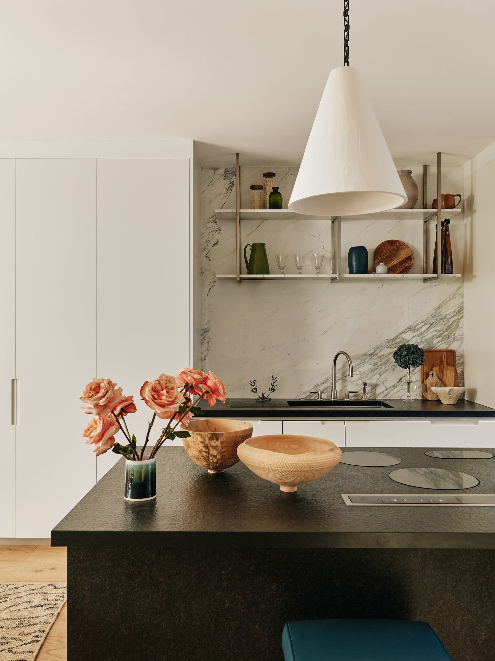 Image may contain Indoors Interior Design Kitchen Sink Sink Faucet Lamp Home Decor Rug Flower Plant and Furniture