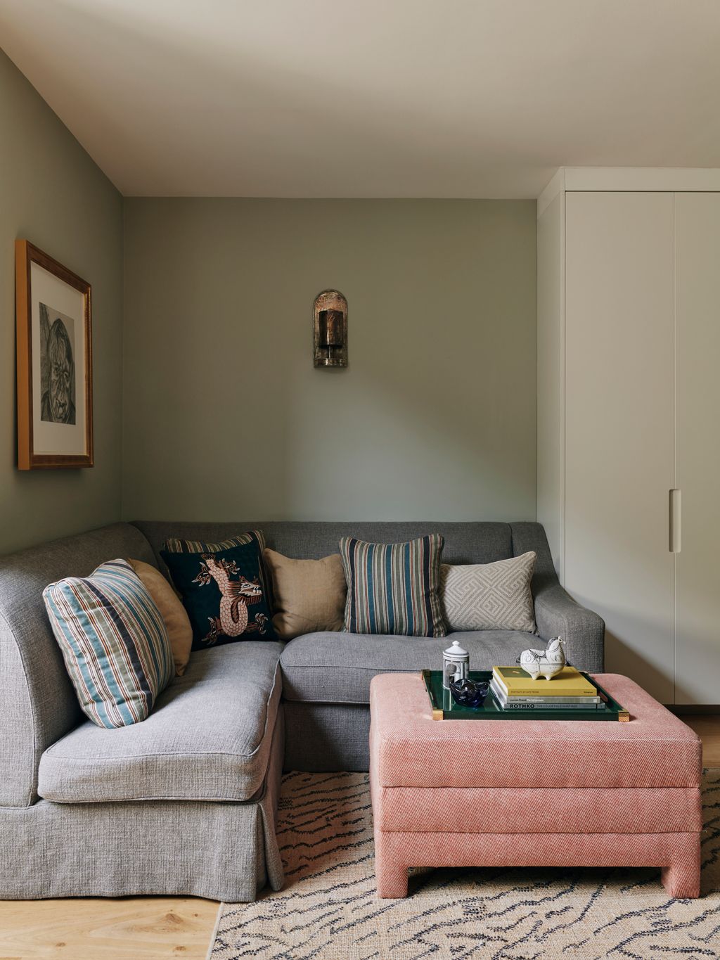 Image may contain Furniture Art Painting Home Decor Couch Rug Person Book Publication Cushion and Architecture