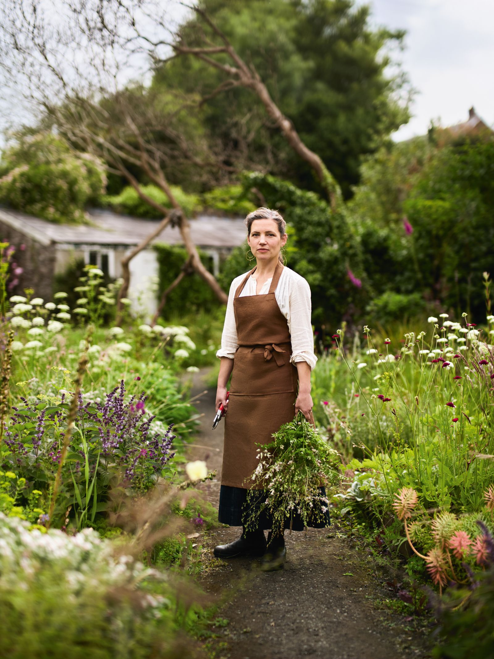 Image may contain Garden Nature Outdoors Adult Person Gardening Clothing Footwear Shoe Herbal Herbs and Plant