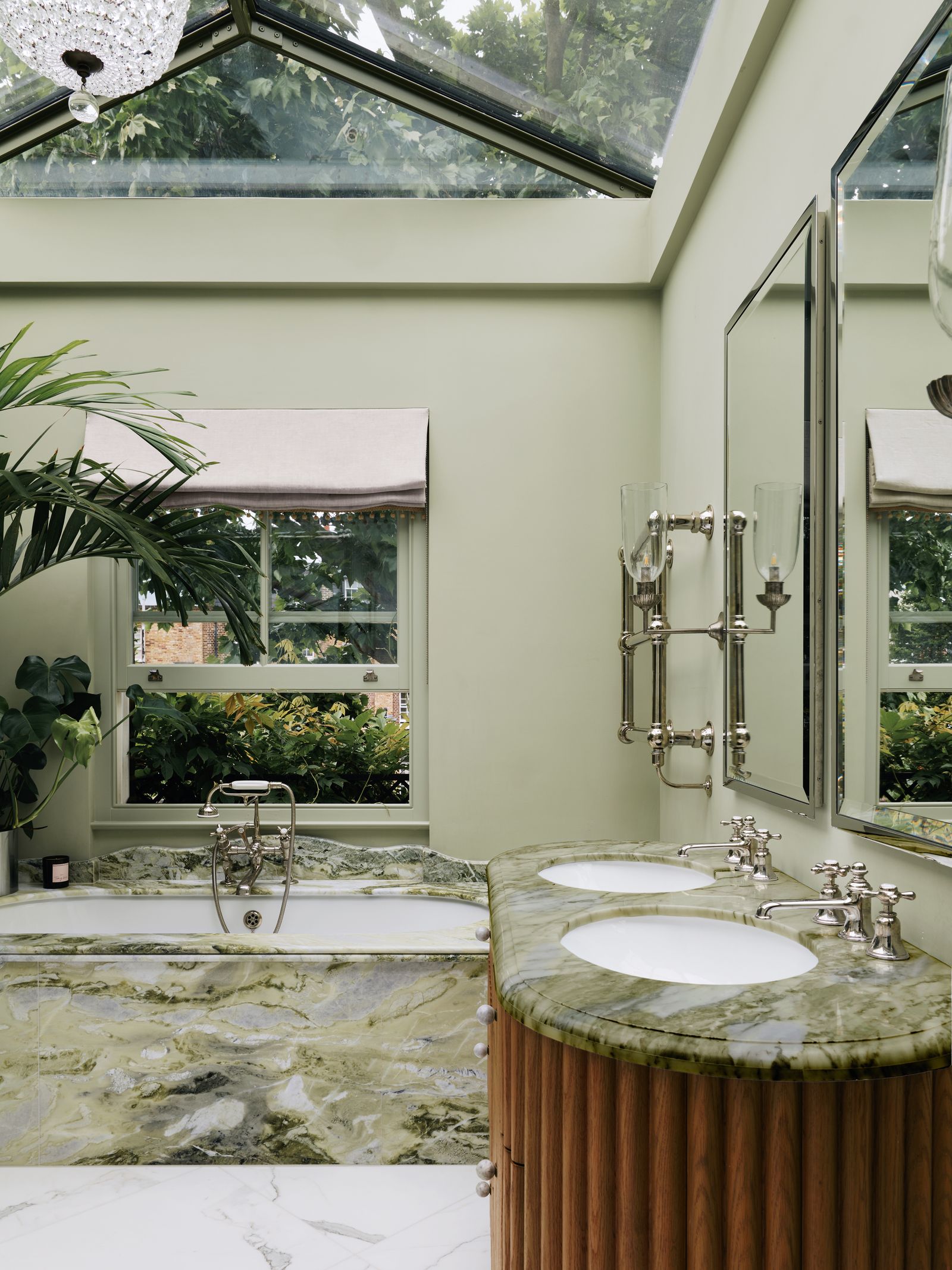 Image may contain Sink Bathing Bathtub Person Tub Sink Faucet Window and Lamp