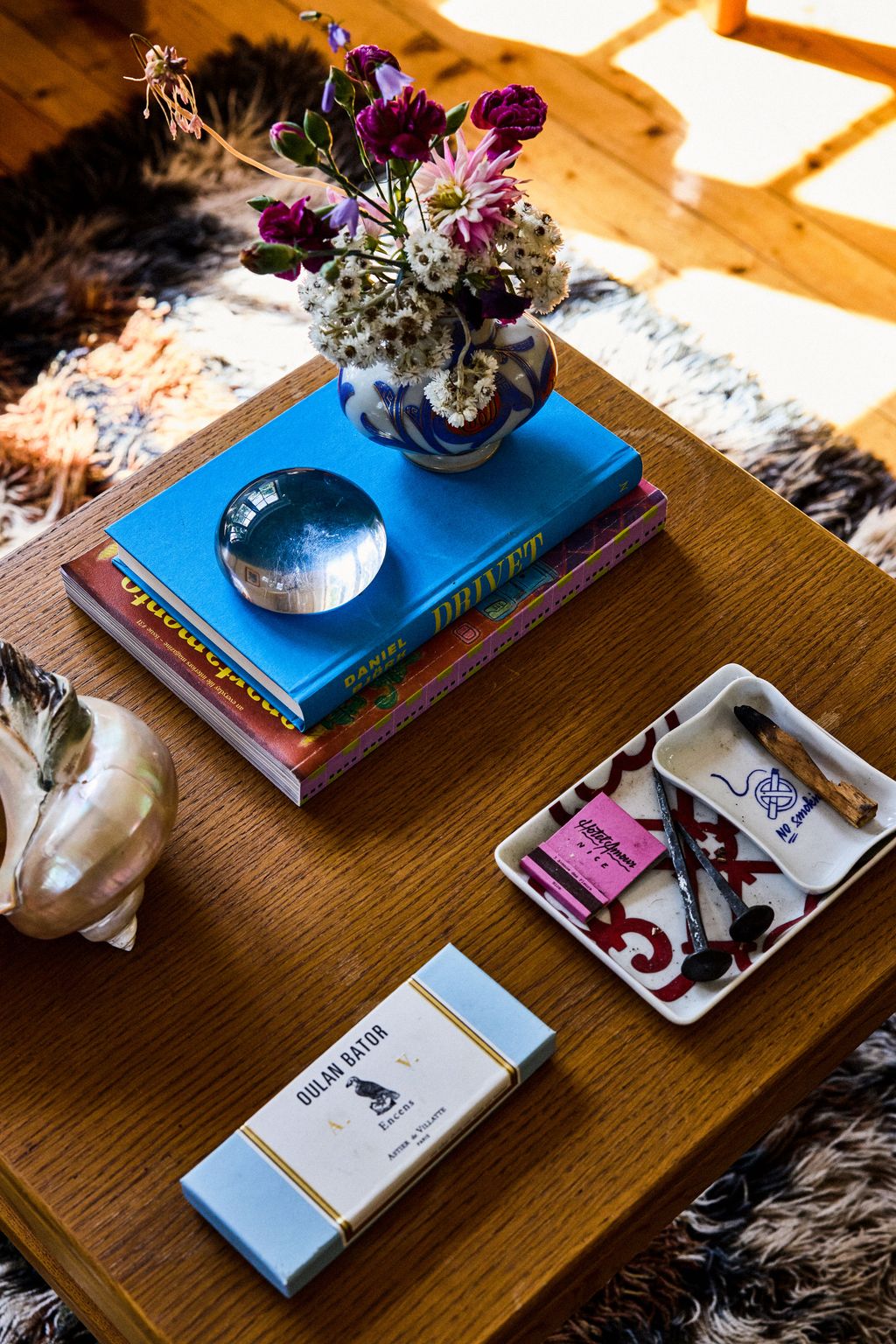 Image may contain Coffee Table Furniture Table Book Publication Flower Flower Arrangement Plant Wood and Hardwood