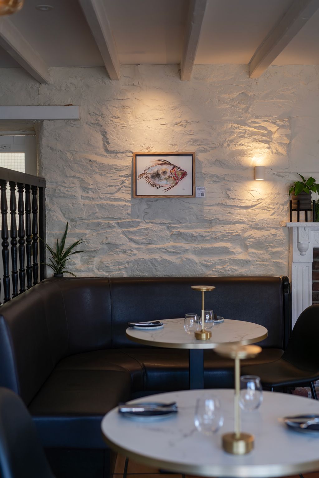 Image may contain Indoors Restaurant Art Painting Furniture Table Plant Interior Design Dining Table and Lamp