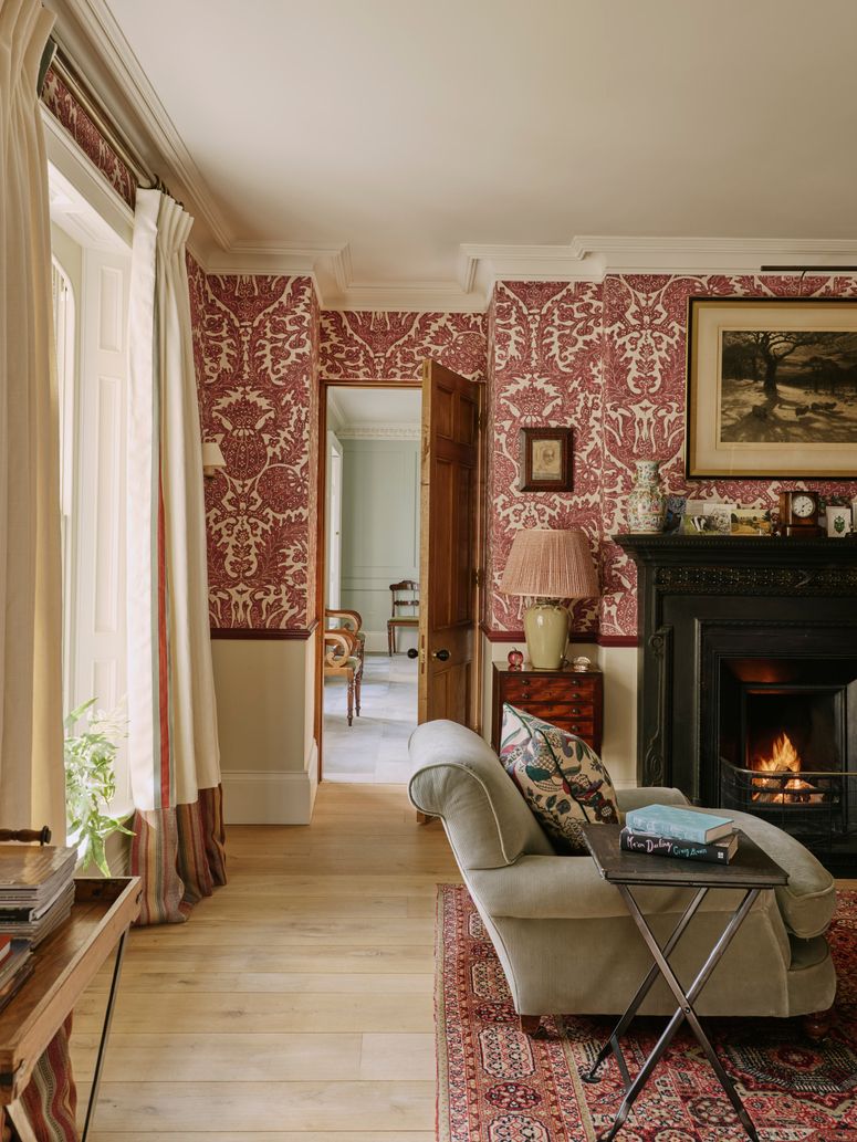 Image may contain: Home Decor, Indoors, Interior Design, Lamp, Chair, Furniture, Art, Painting, Book, and Publication