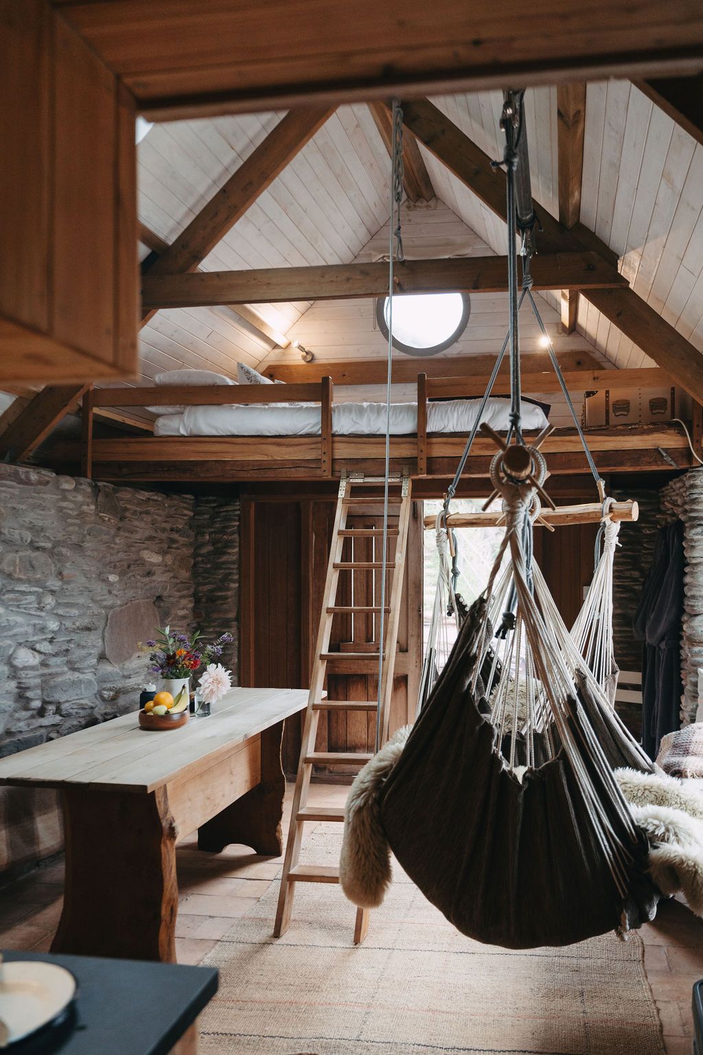 Image may contain Indoors Interior Design Desk Furniture Table Plate Wood Bed Architecture Building and House