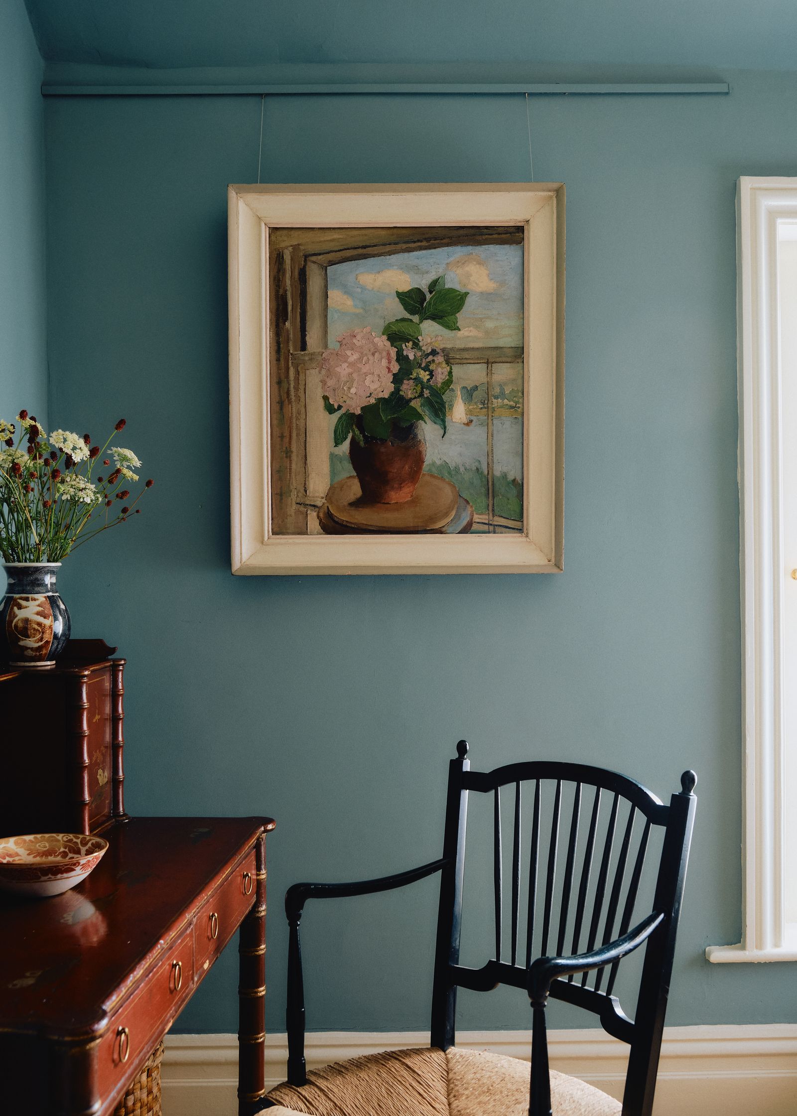 Image may contain Chair Furniture Art Painting Indoors Interior Design Desk Table and Photo Frame